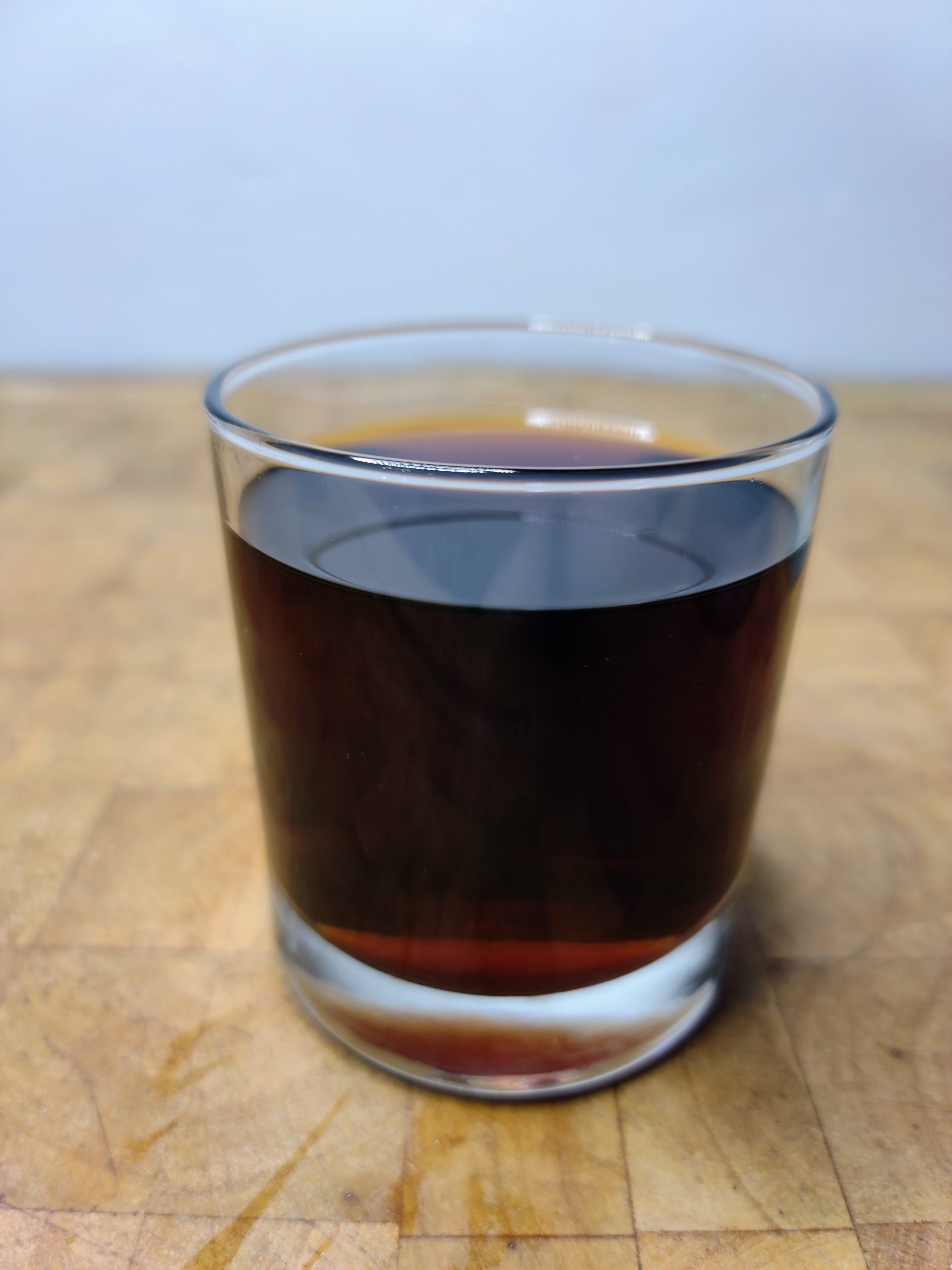 closeup of russian coffee in a rocks glass on a wooden table