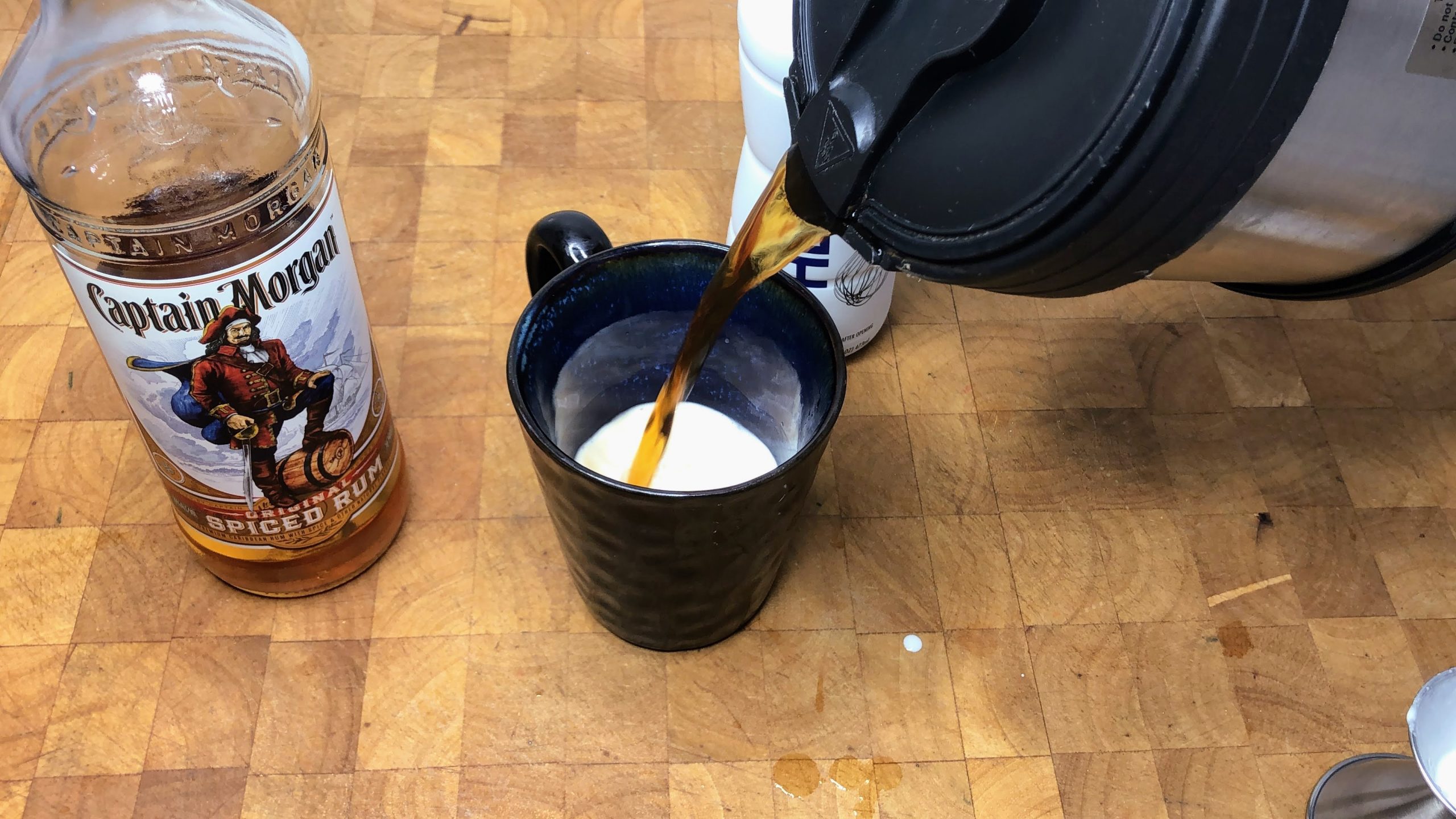 pouring hot coffee into a mug