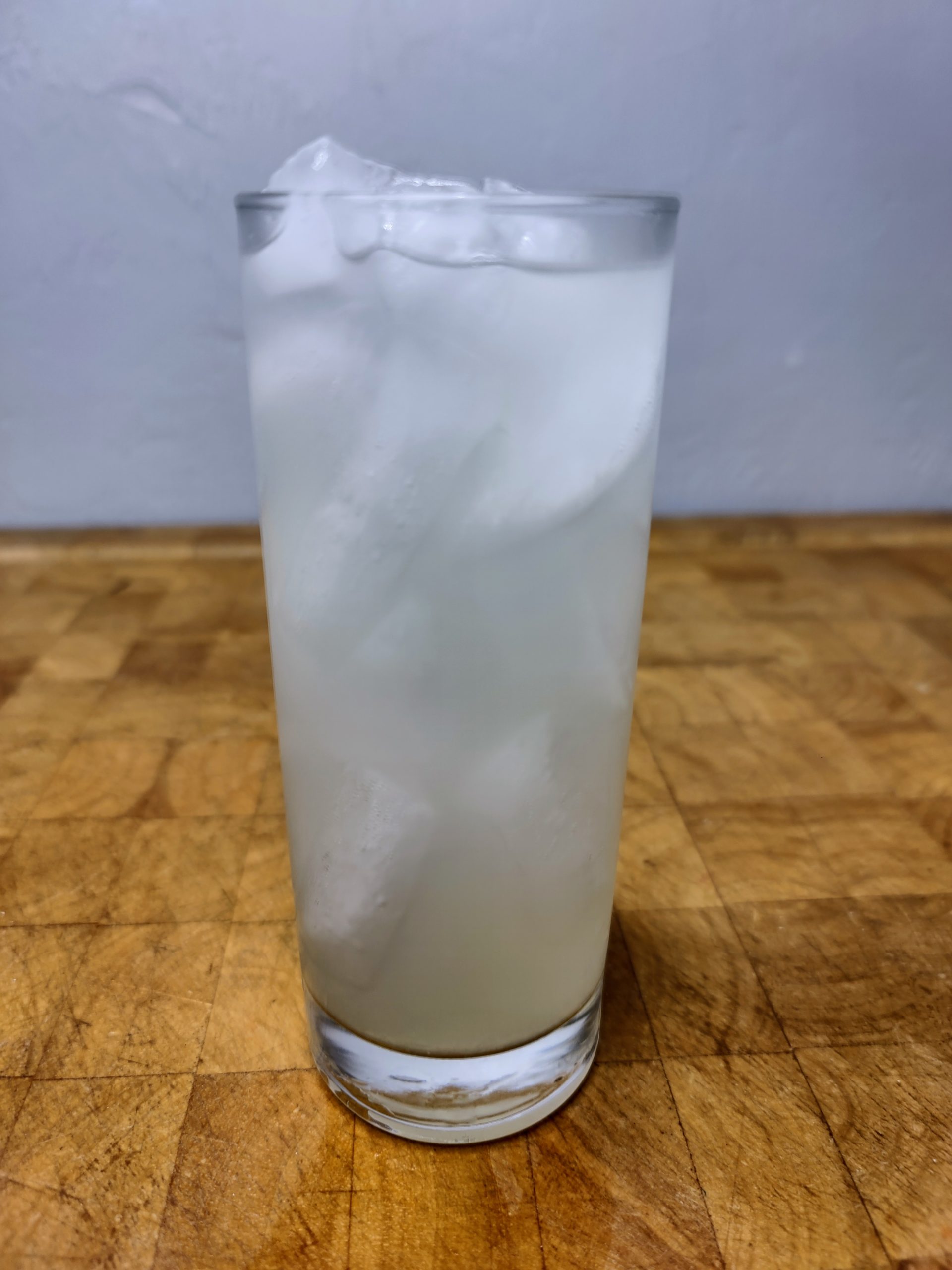 vodka limeade in a highball glass on a wooden table