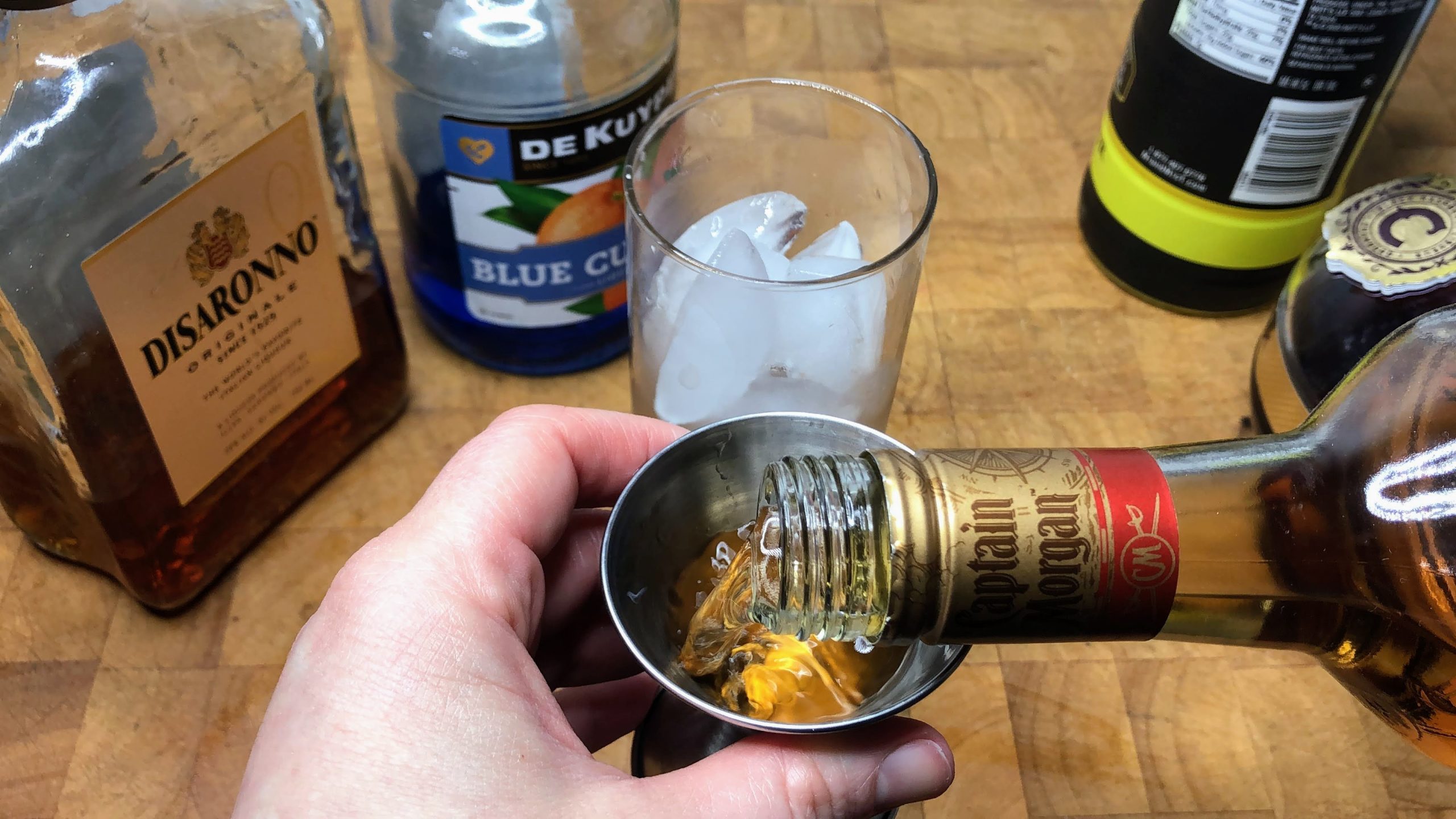 measuring spiced rum with jigger
