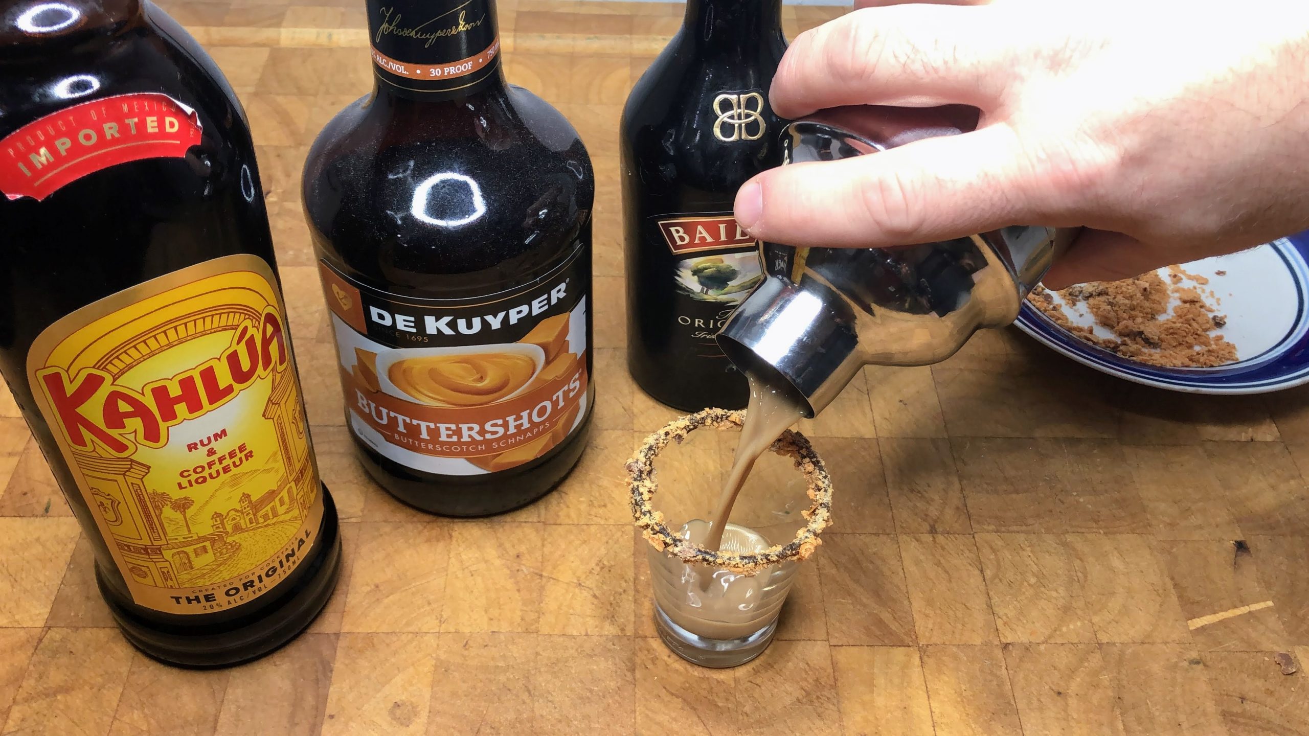 pouring butterfinger shot into a shot glass