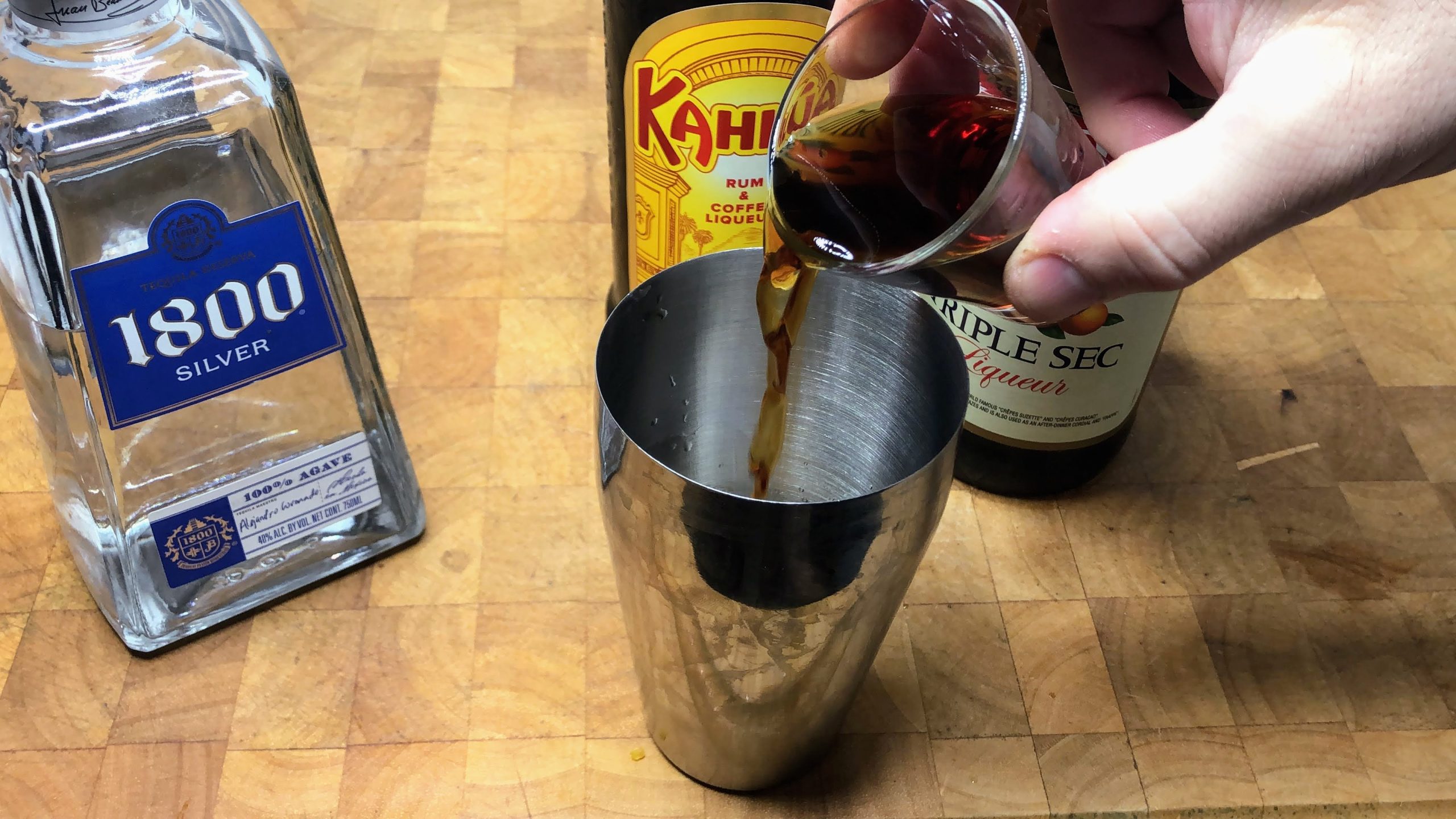 adding cold brew to cocktail shaker