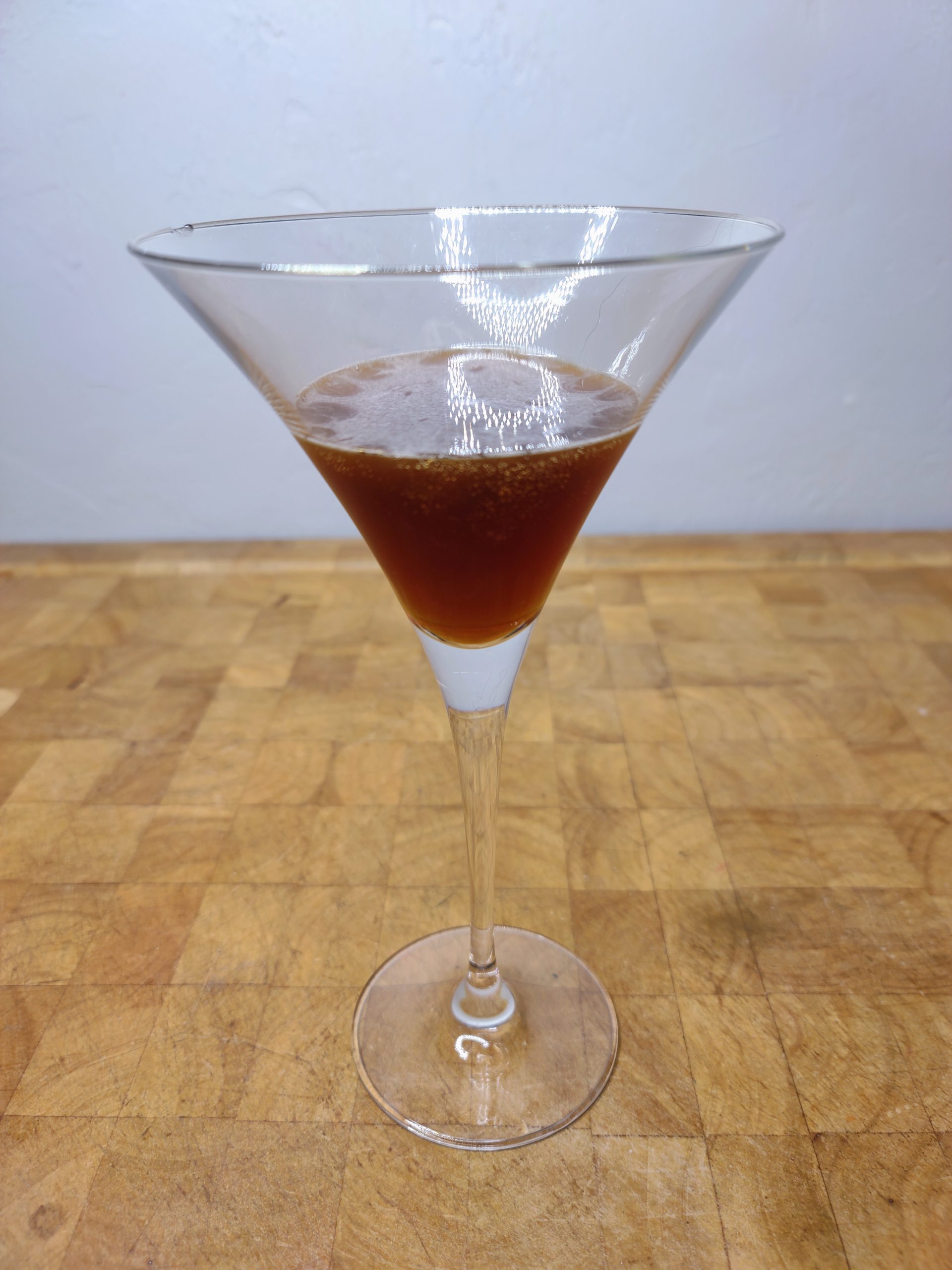 closeup of espresso martini on a wooden table
