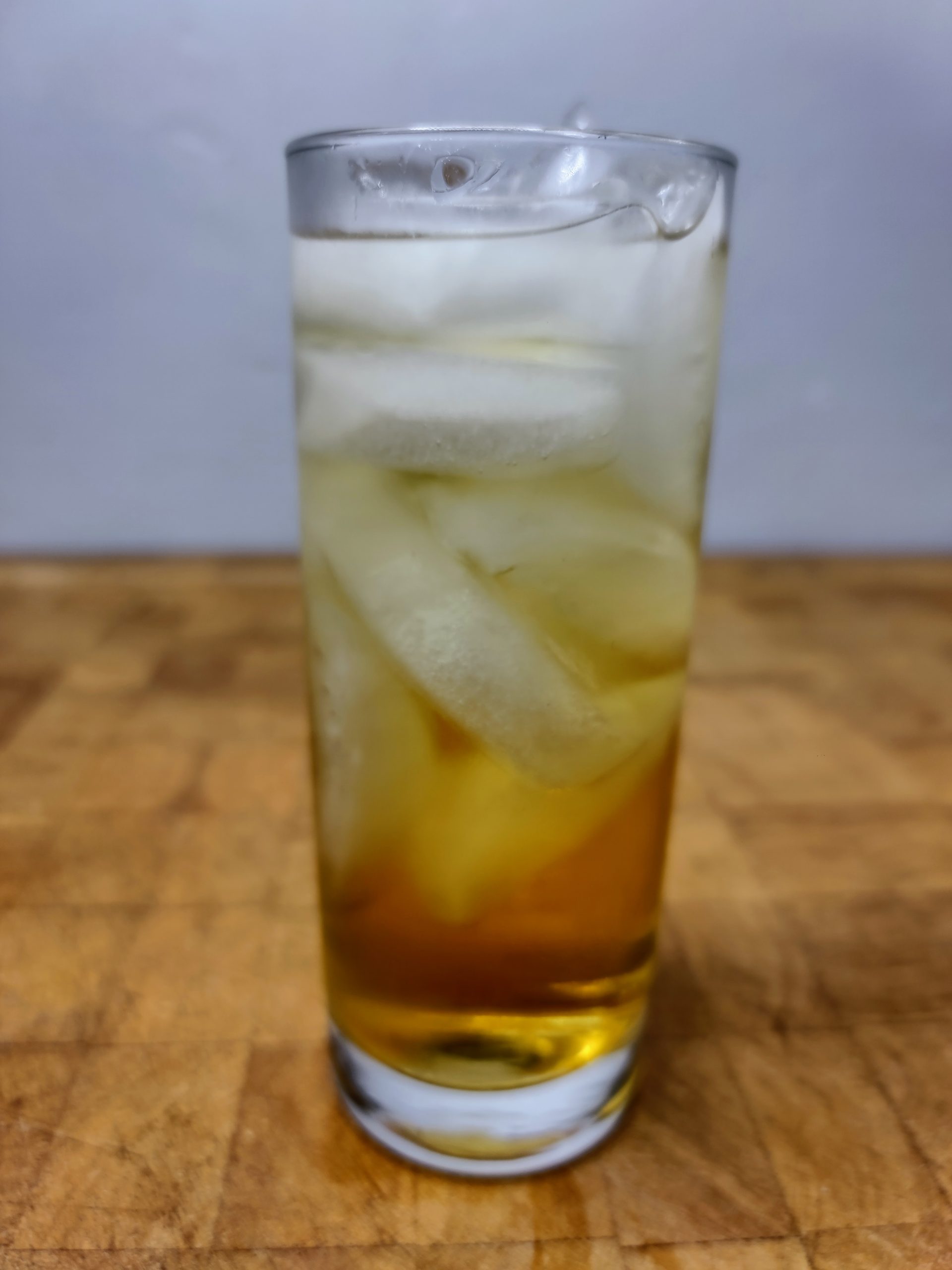 closeup of fireball and sprite in a highball glass on a wooden table