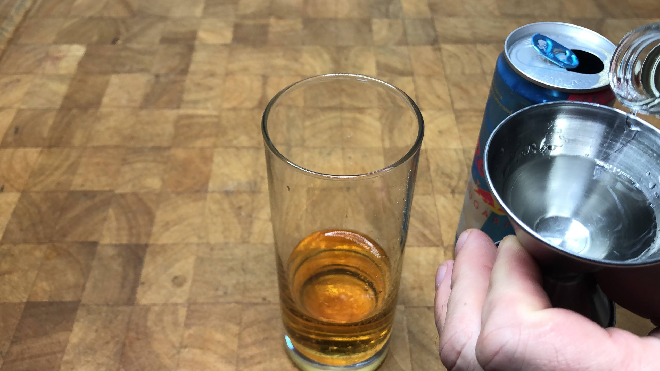 pouring goldschlager into a shot glass
