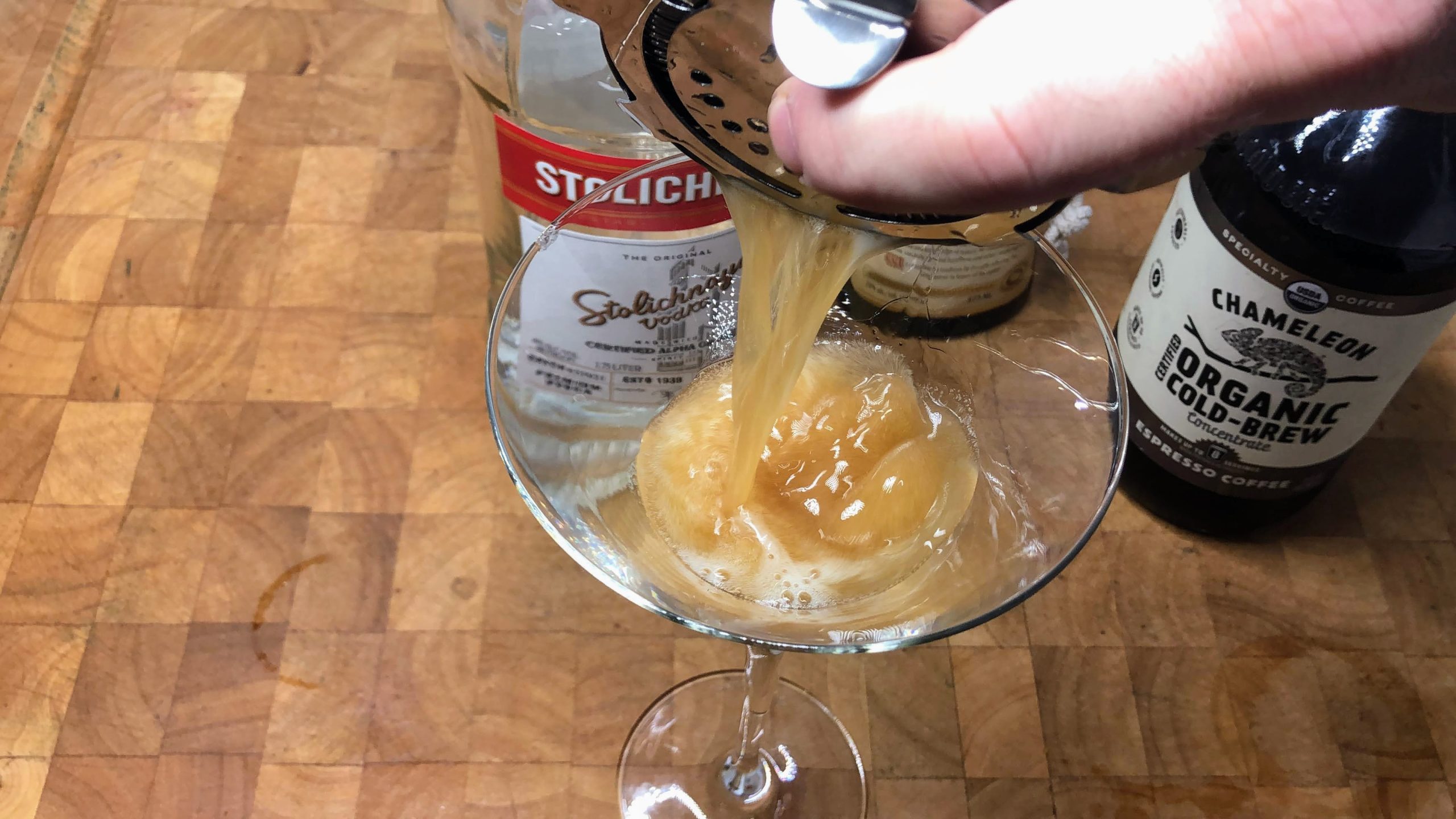 pouring hazelnut espresso martini into a glass