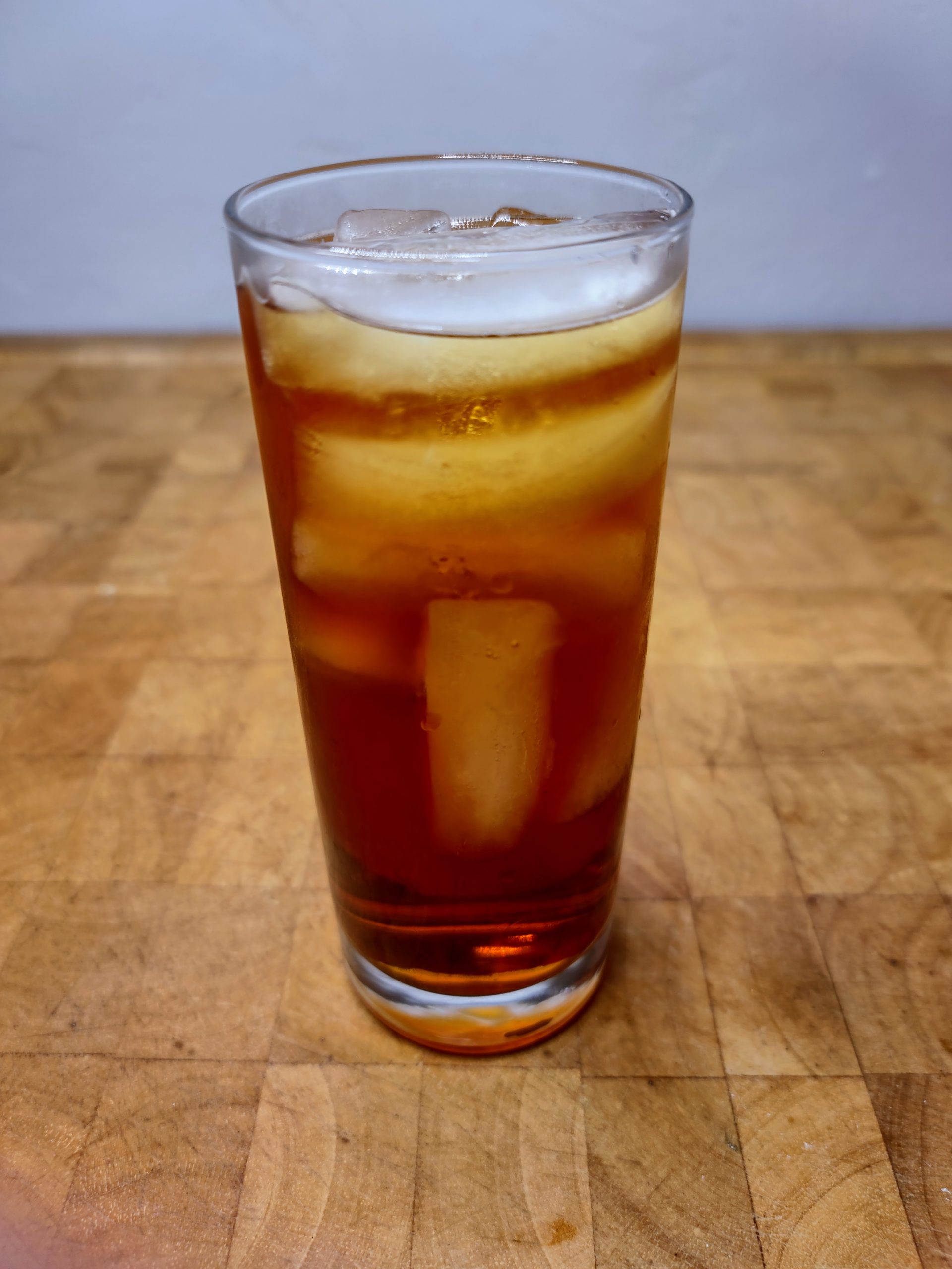 jager and sprite in a highball glass on a wooden table