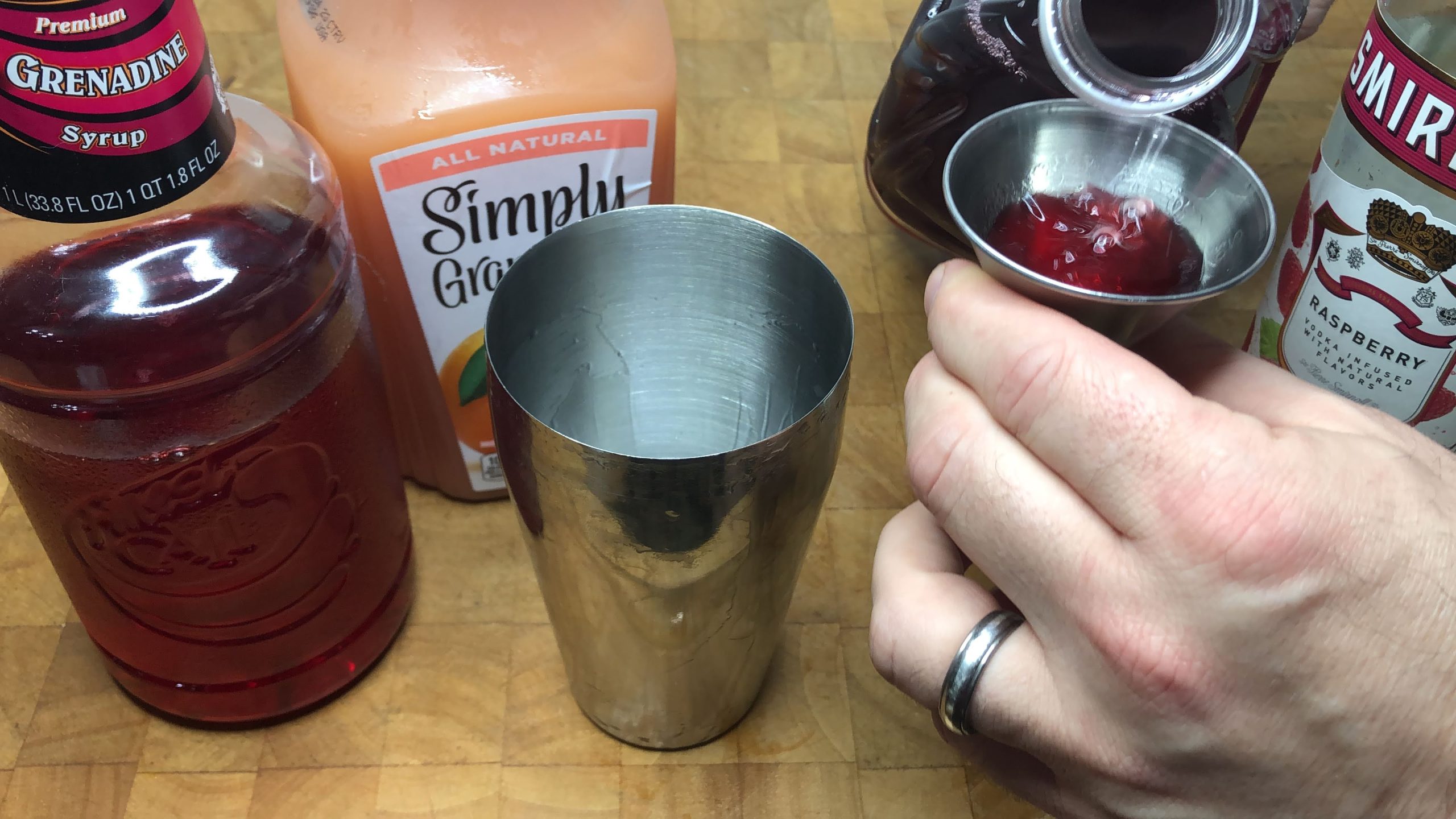 measuring cranberry juice in a jiggr