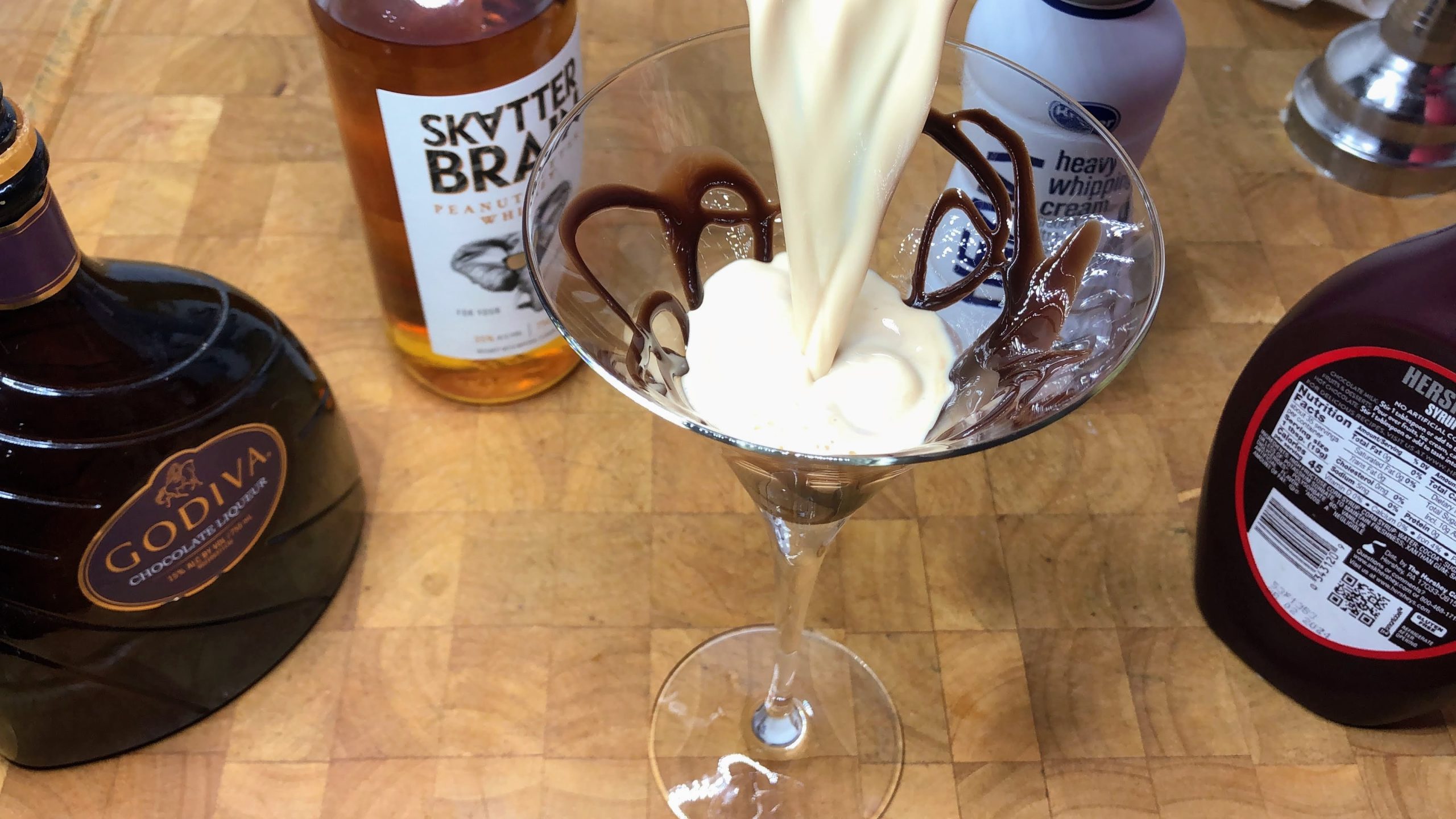 pouring peanut butter cup martini into a glass