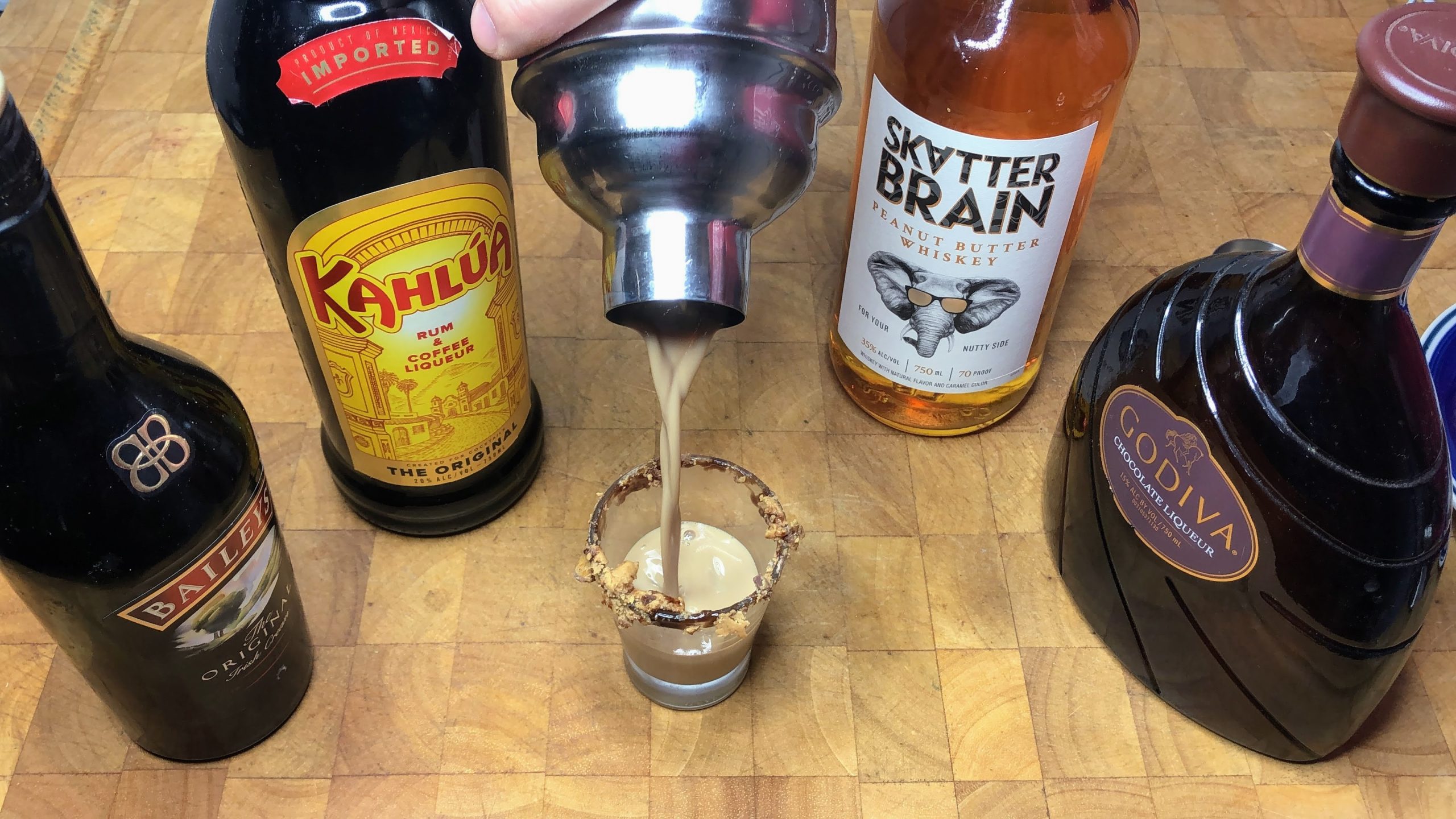 pouring peanut butter cup shot from shaker into shot glass