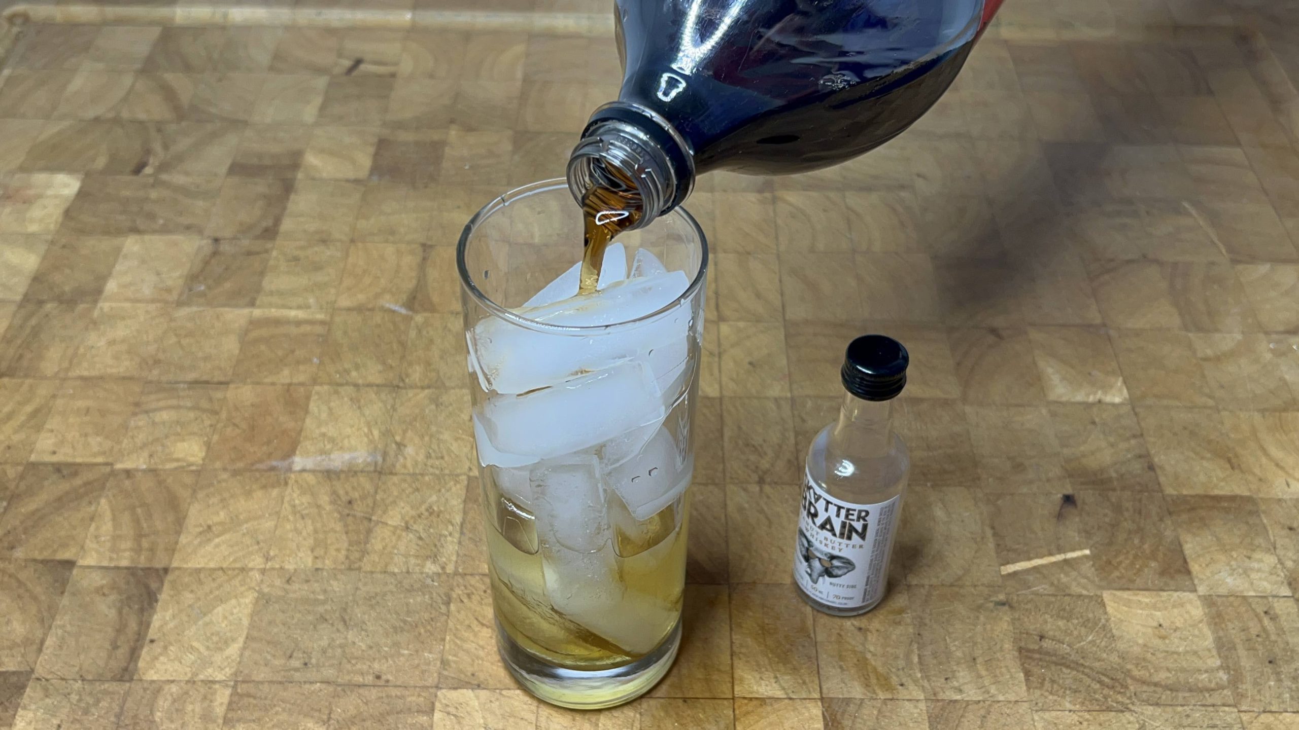 pouring coke into a highball glass