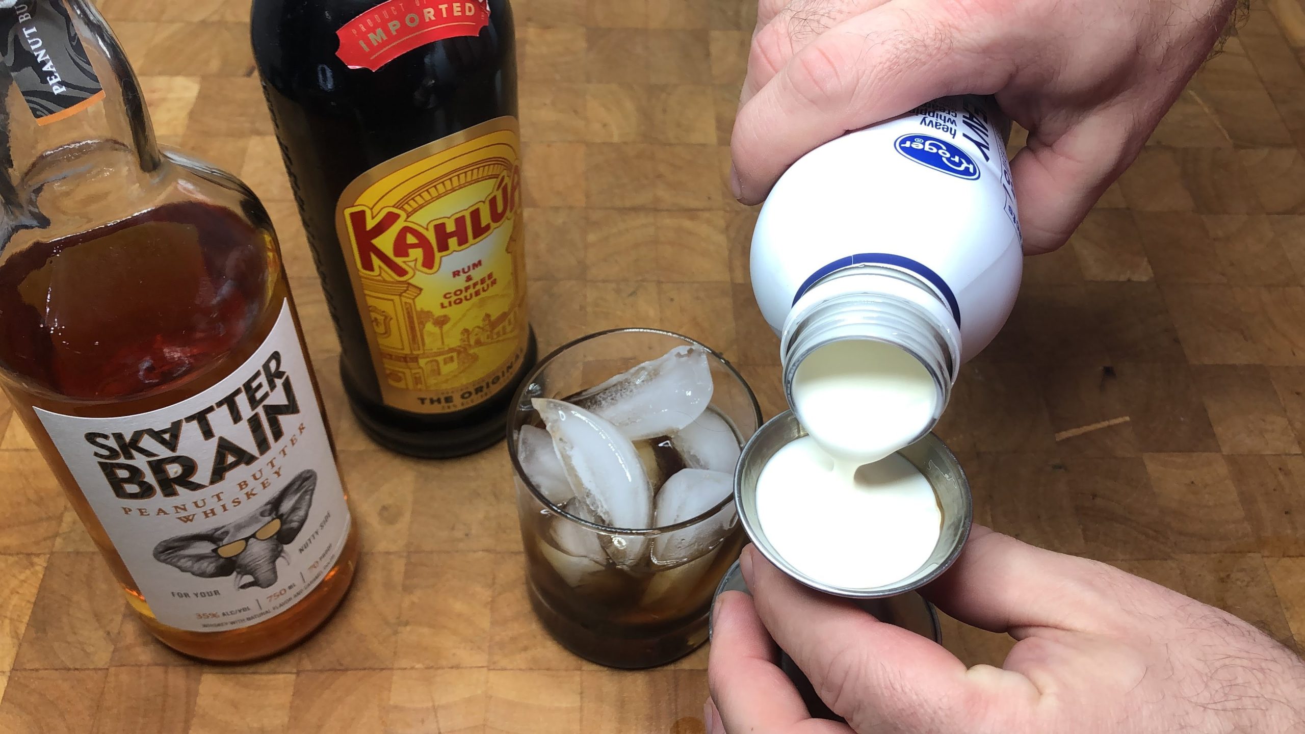 pouring heavy cream in a jigger