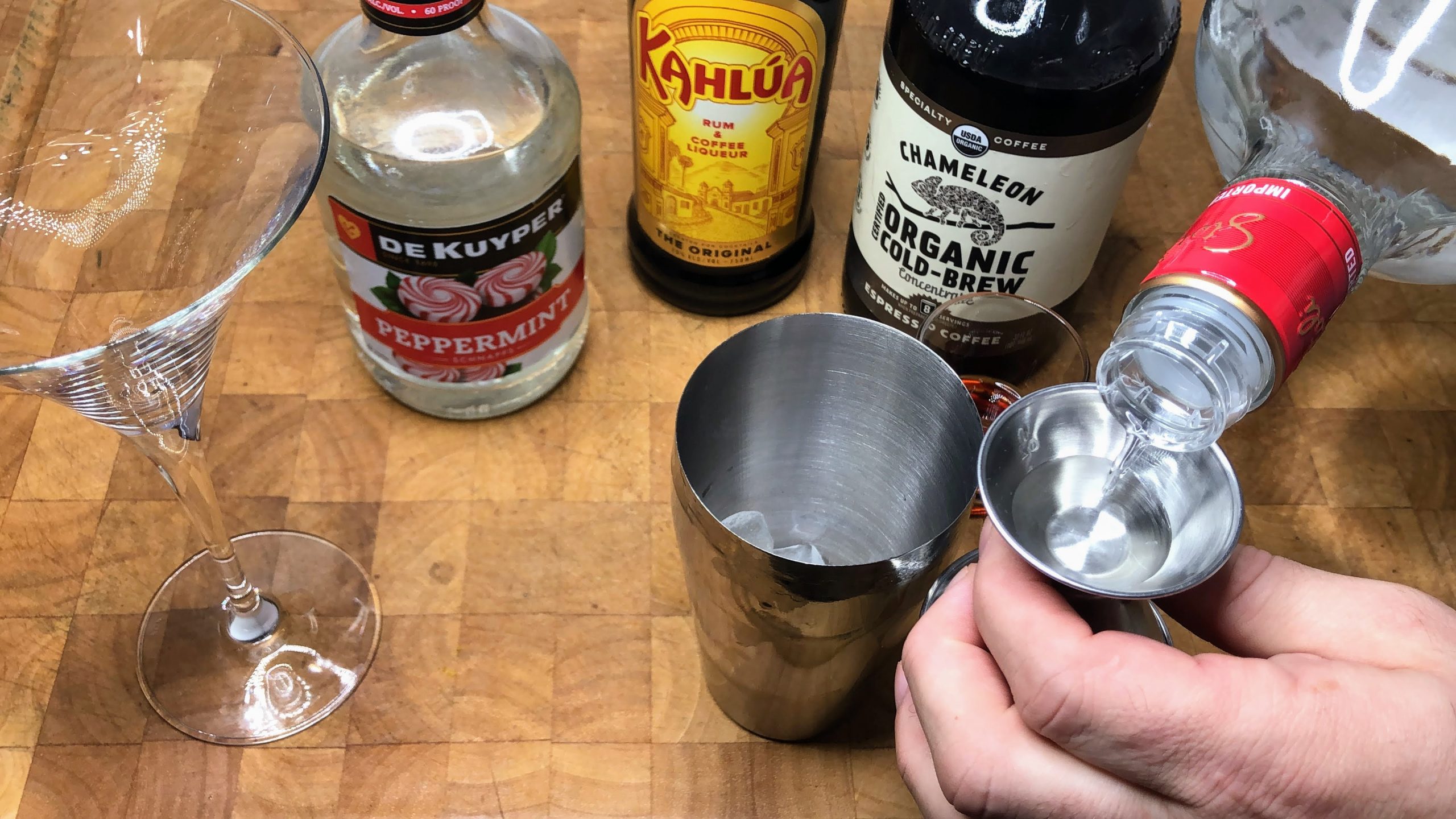 measuring out vodka in a jigger