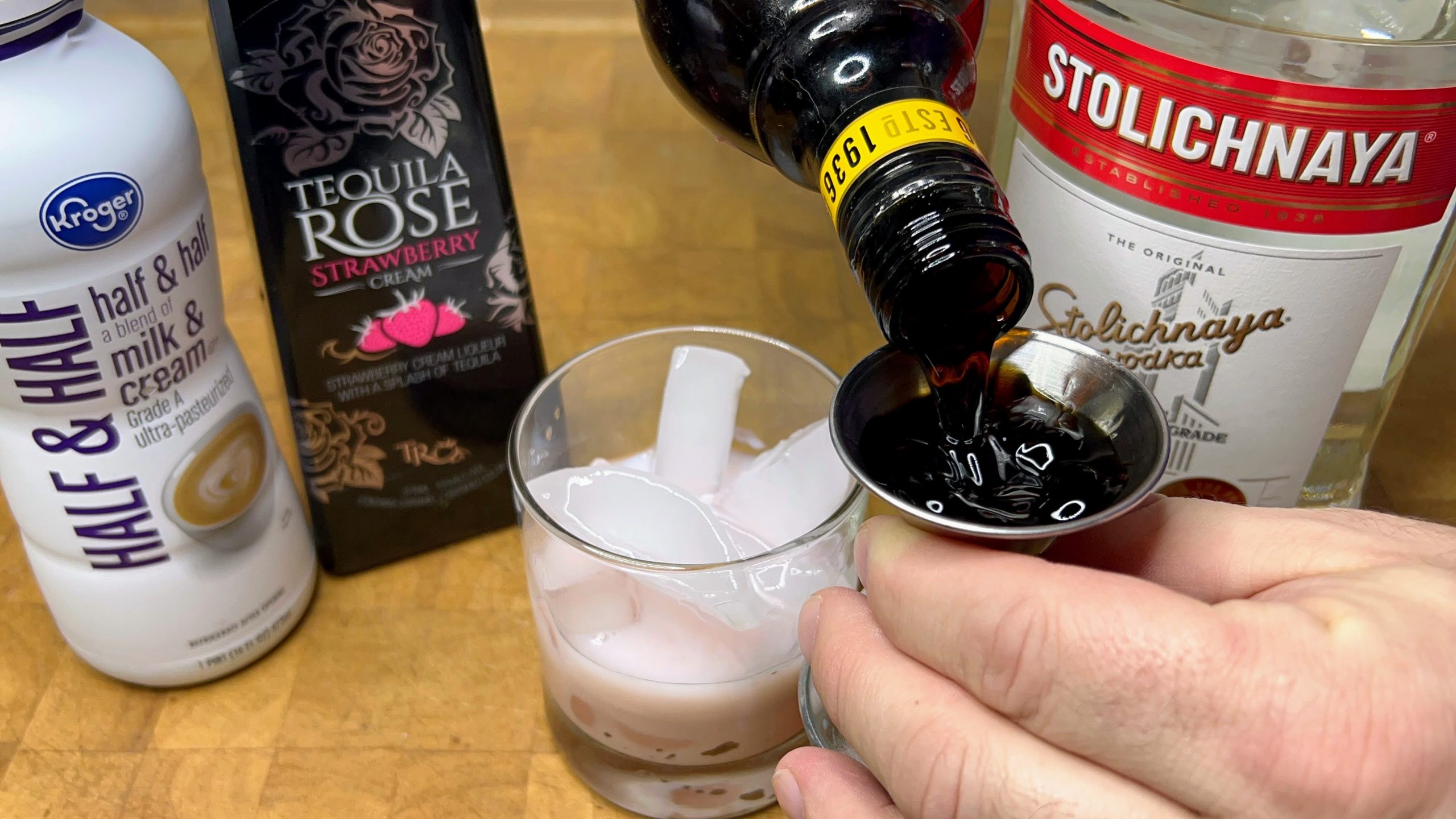 pouring kahlua in a jigger