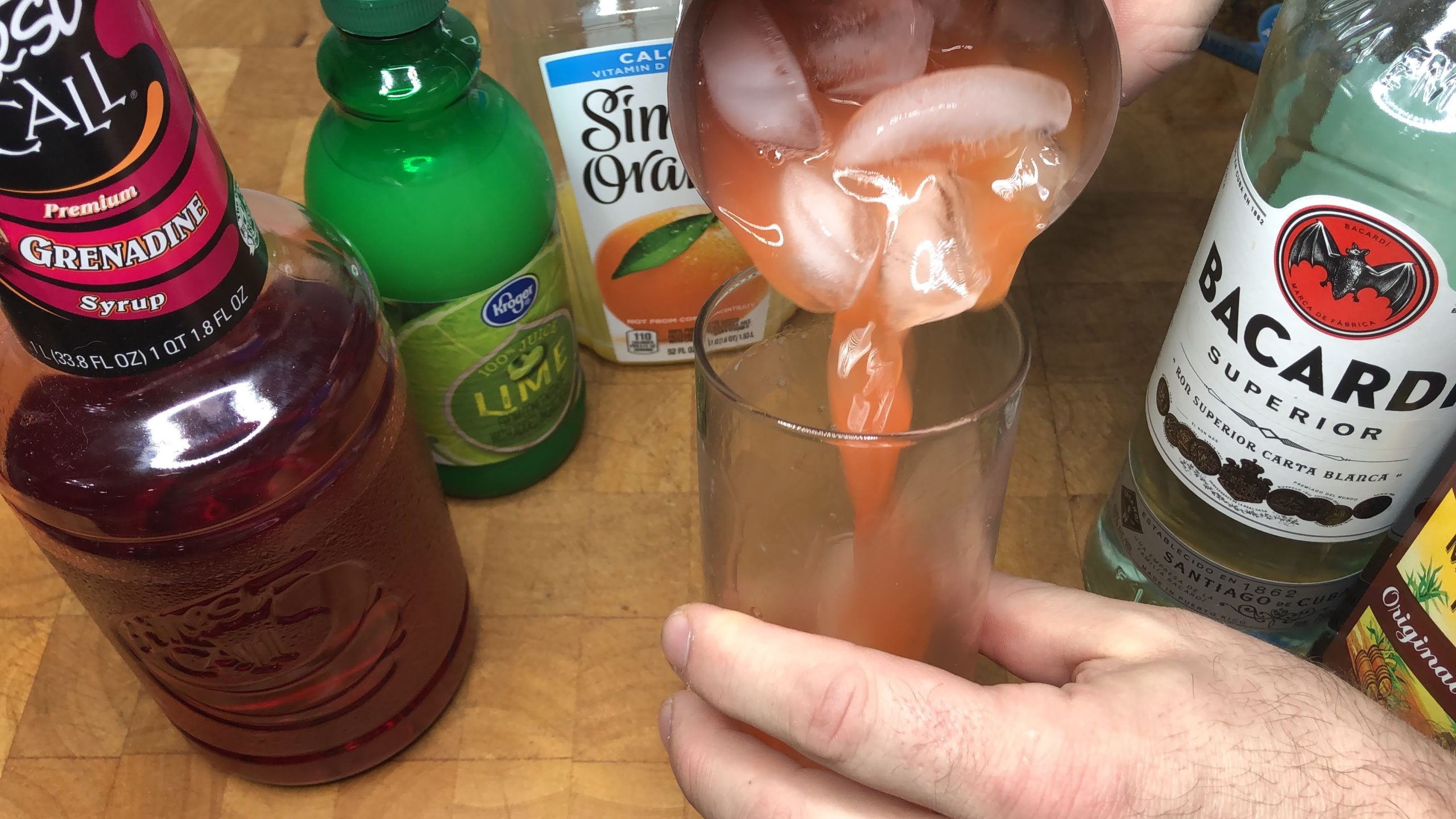 mixing rum punch in a jigger