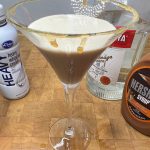 salted caramel martini with ingredient bottles next to the glass