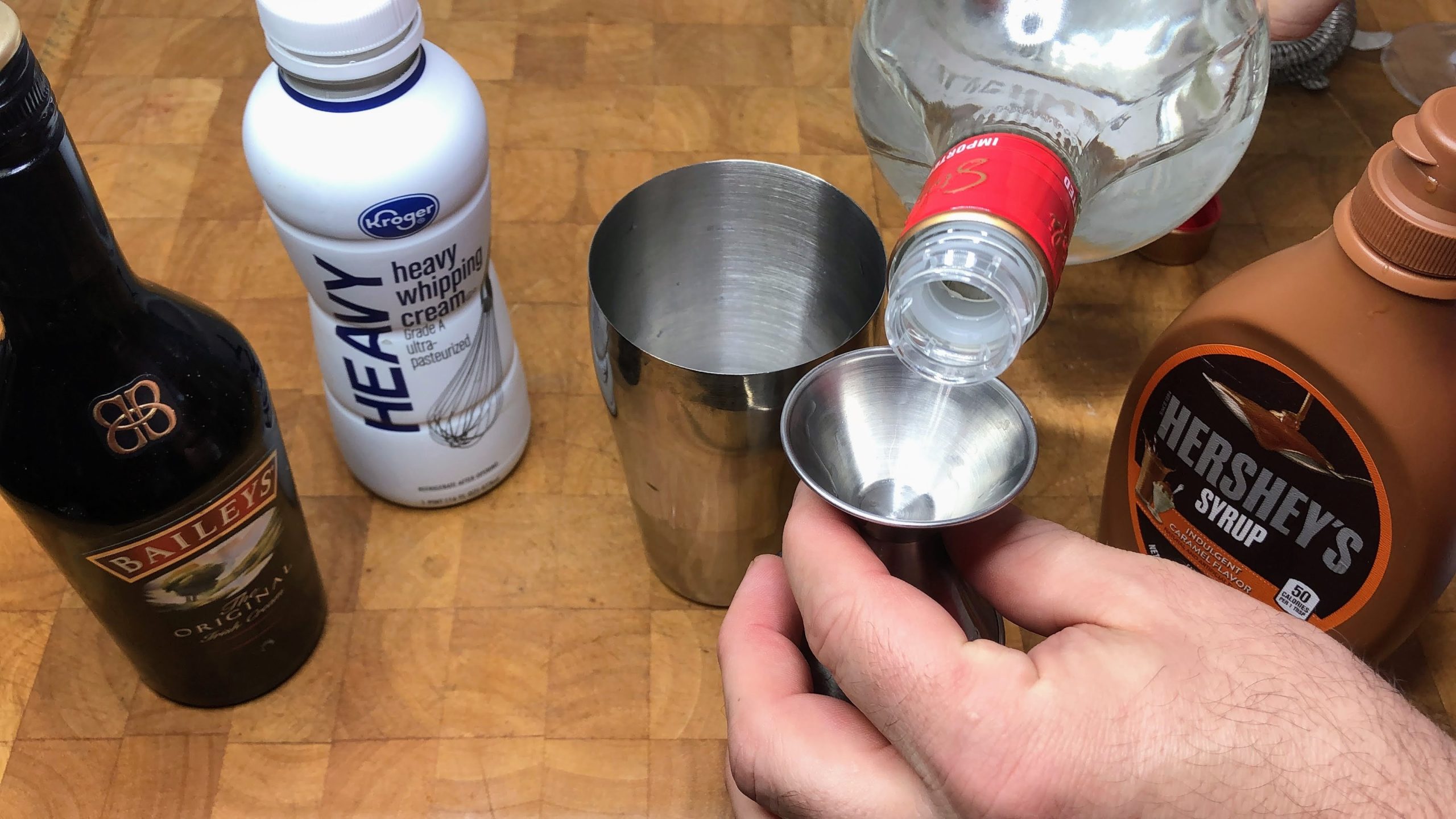measuring vodka in a jigger