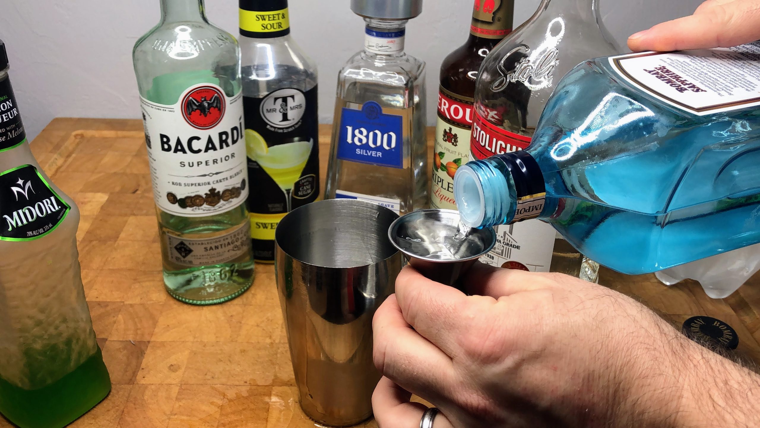 pouring gin in jigger