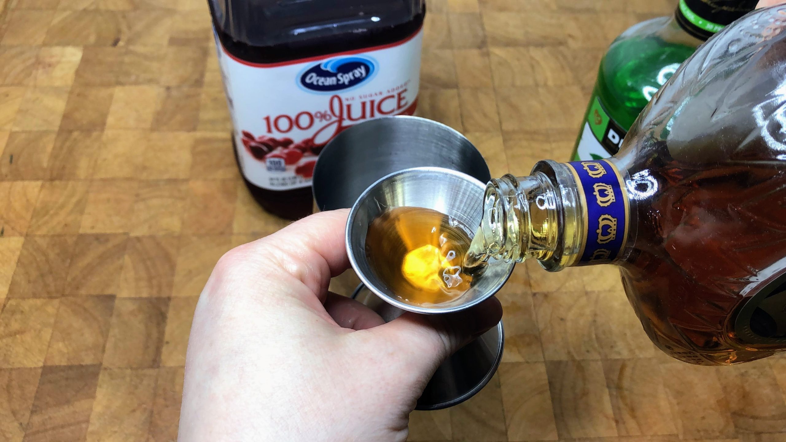 pouring crown royal into a jigger