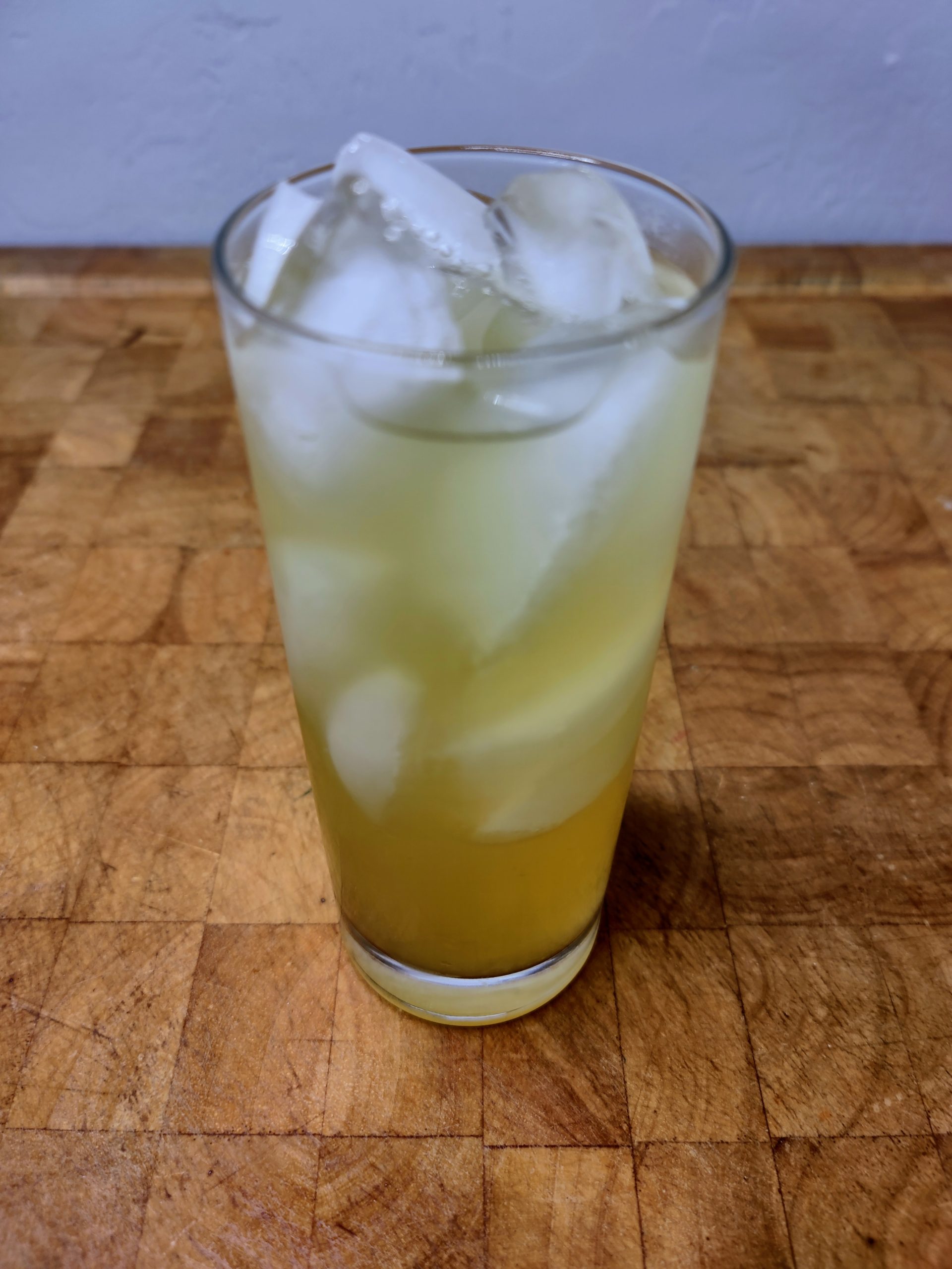whiskey and limeade in a highball glass on a wooden table