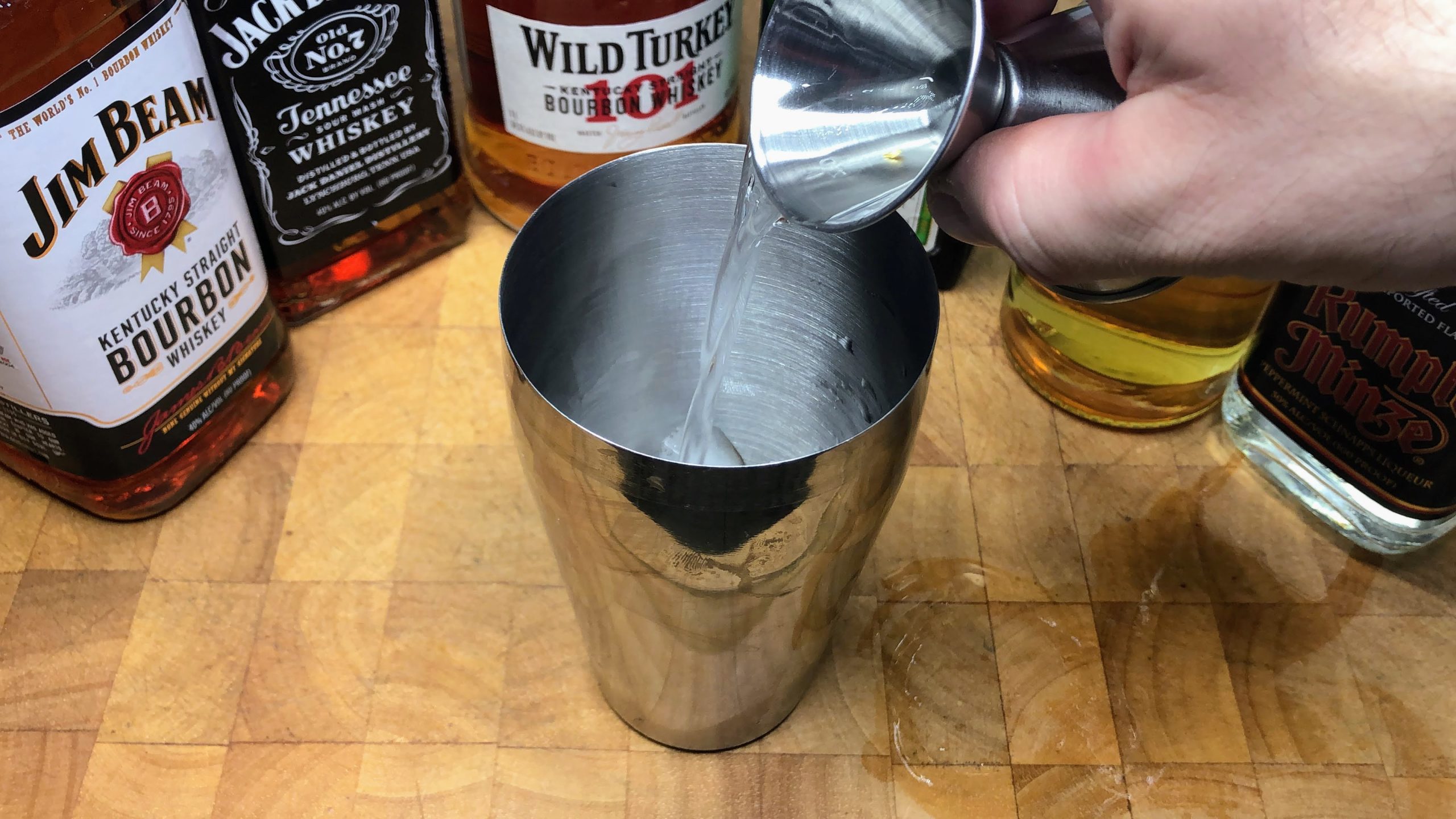 Pouring goldschlager into a shaker