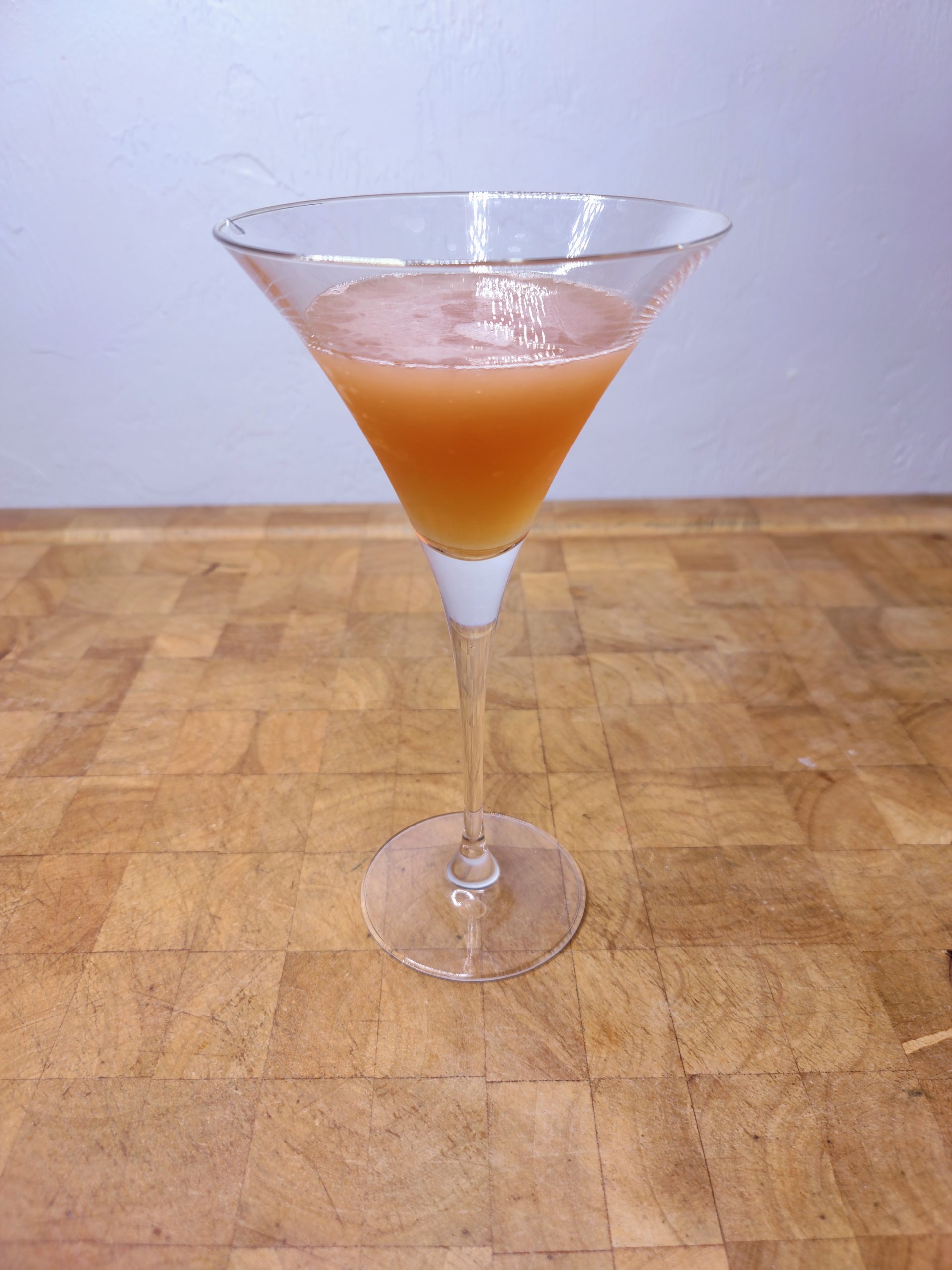 Peanut butter and jelly martini on a wooden table.
