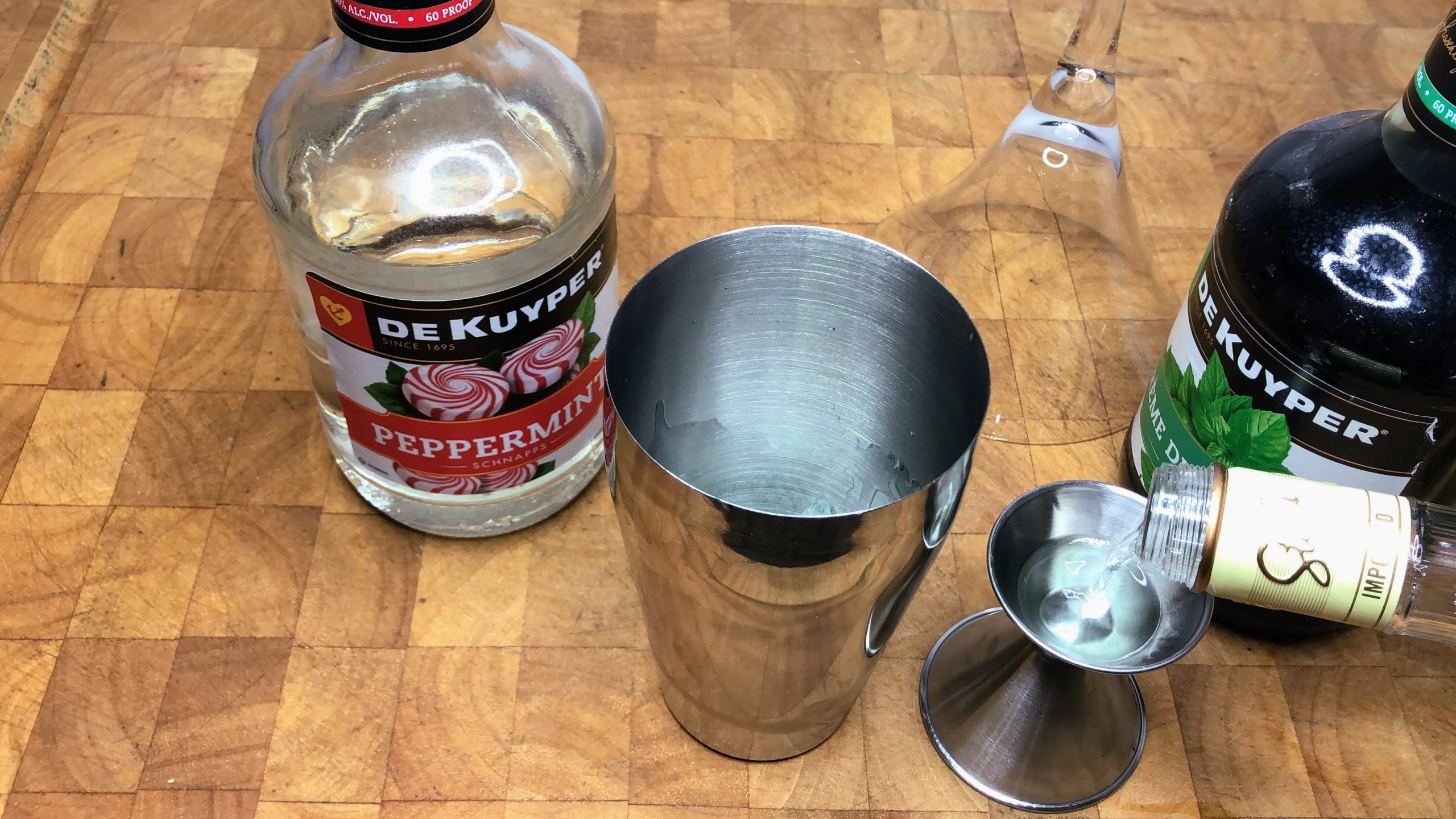 Pouring vanilla vodka into a jigger.