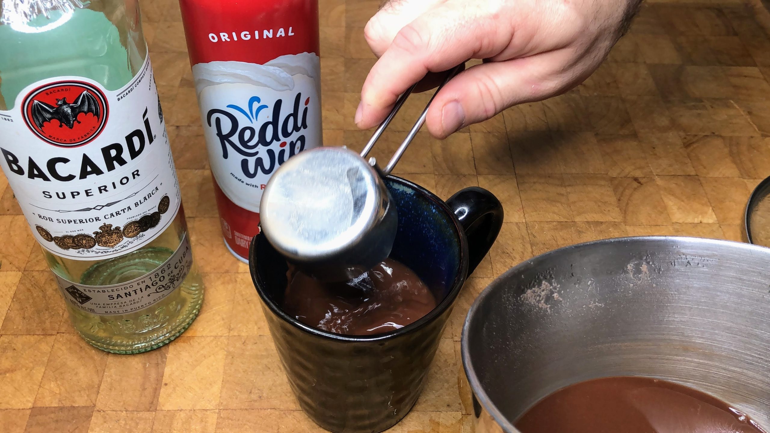 Pouring hot chocolate into a mug.