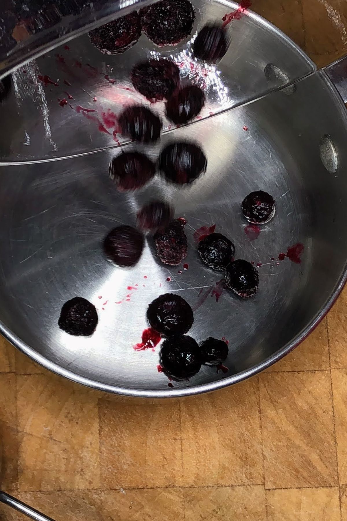 Pouring blueberries into a pot.