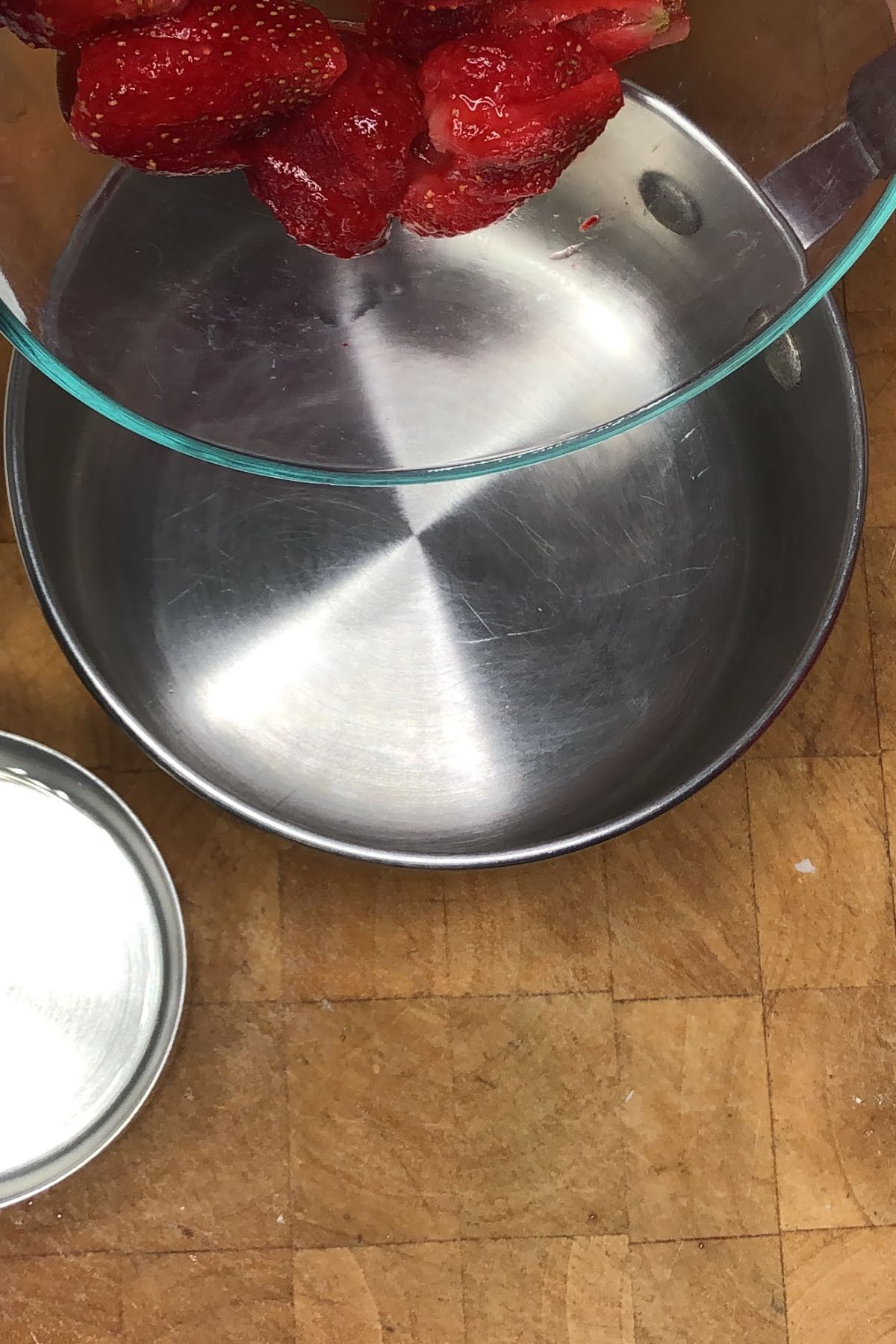 Pouring strawberries into a pot.