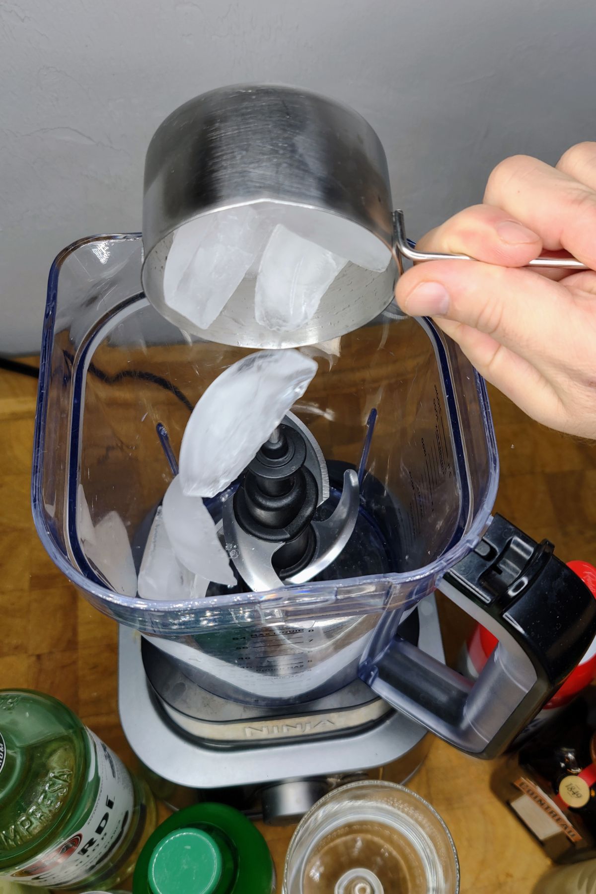 Adding ice to a blender.