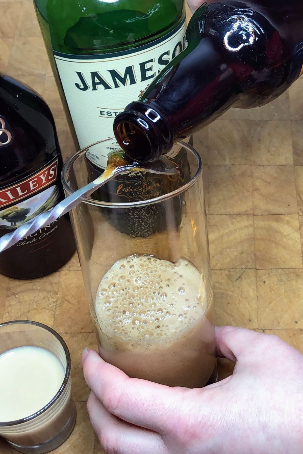 Pouring guiness into a highball glass.
