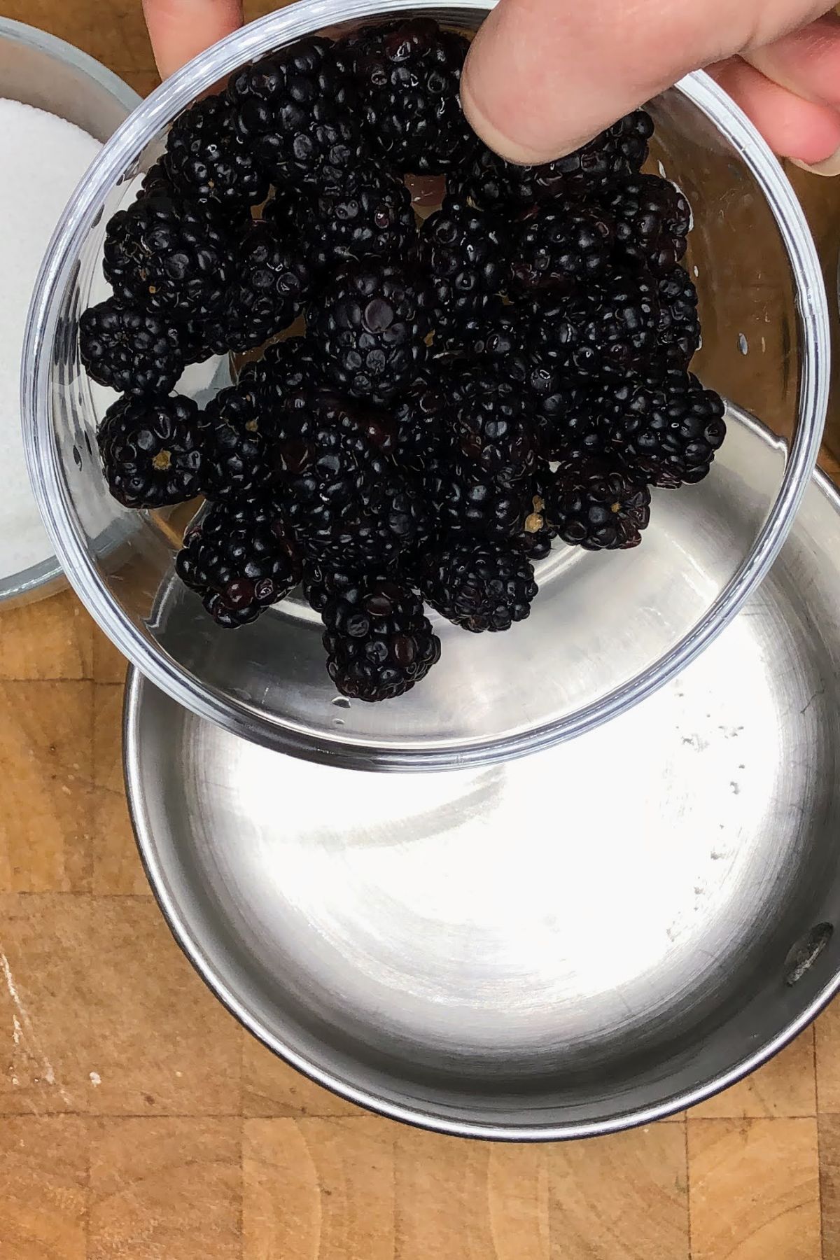 Pouring blackberries into a pot.