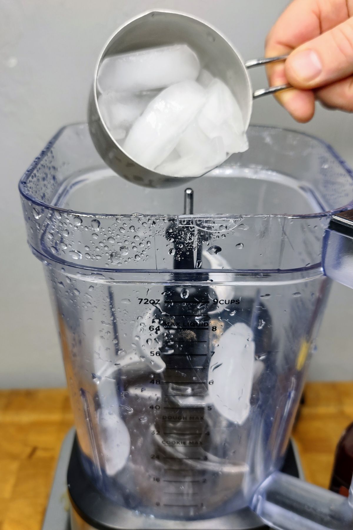 Adding ice to a blender.