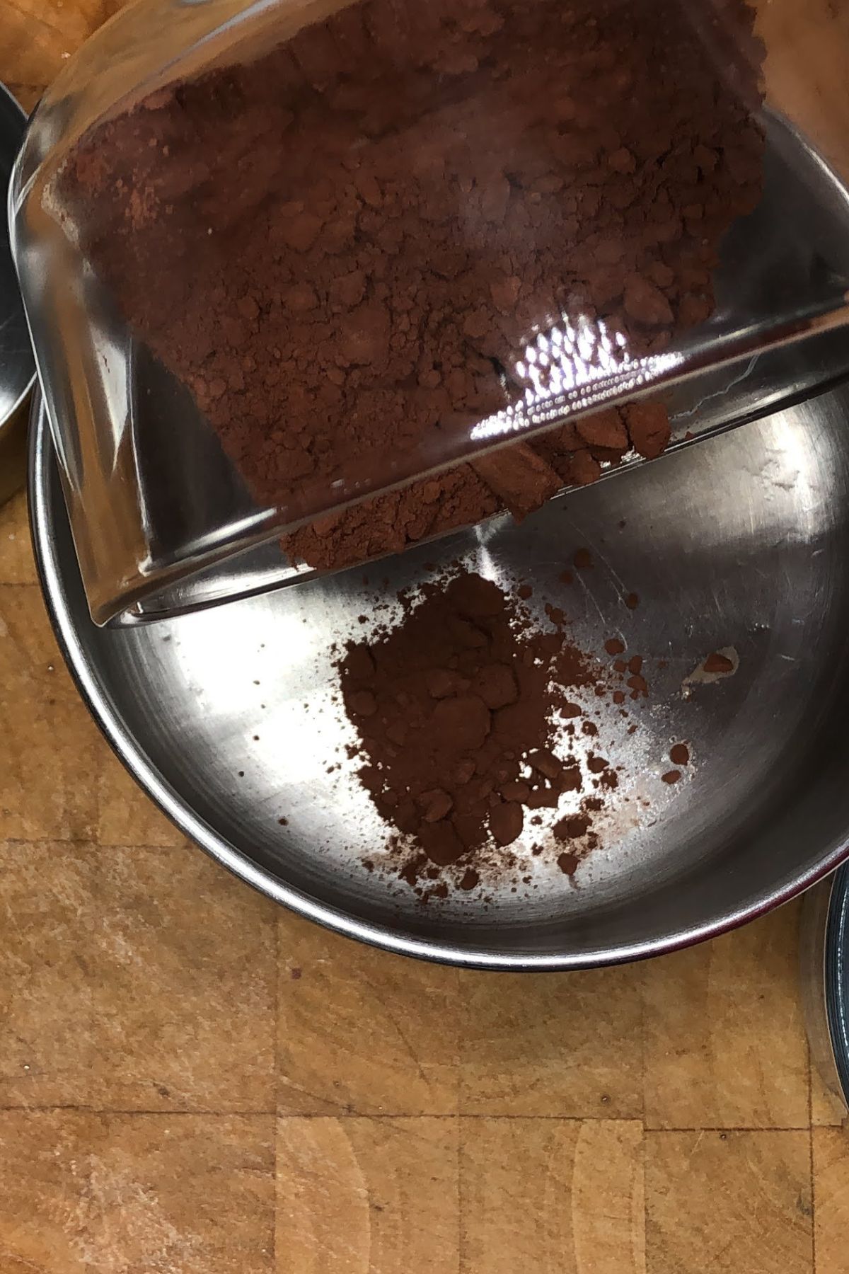 Pouring chocolate into a saucepan.