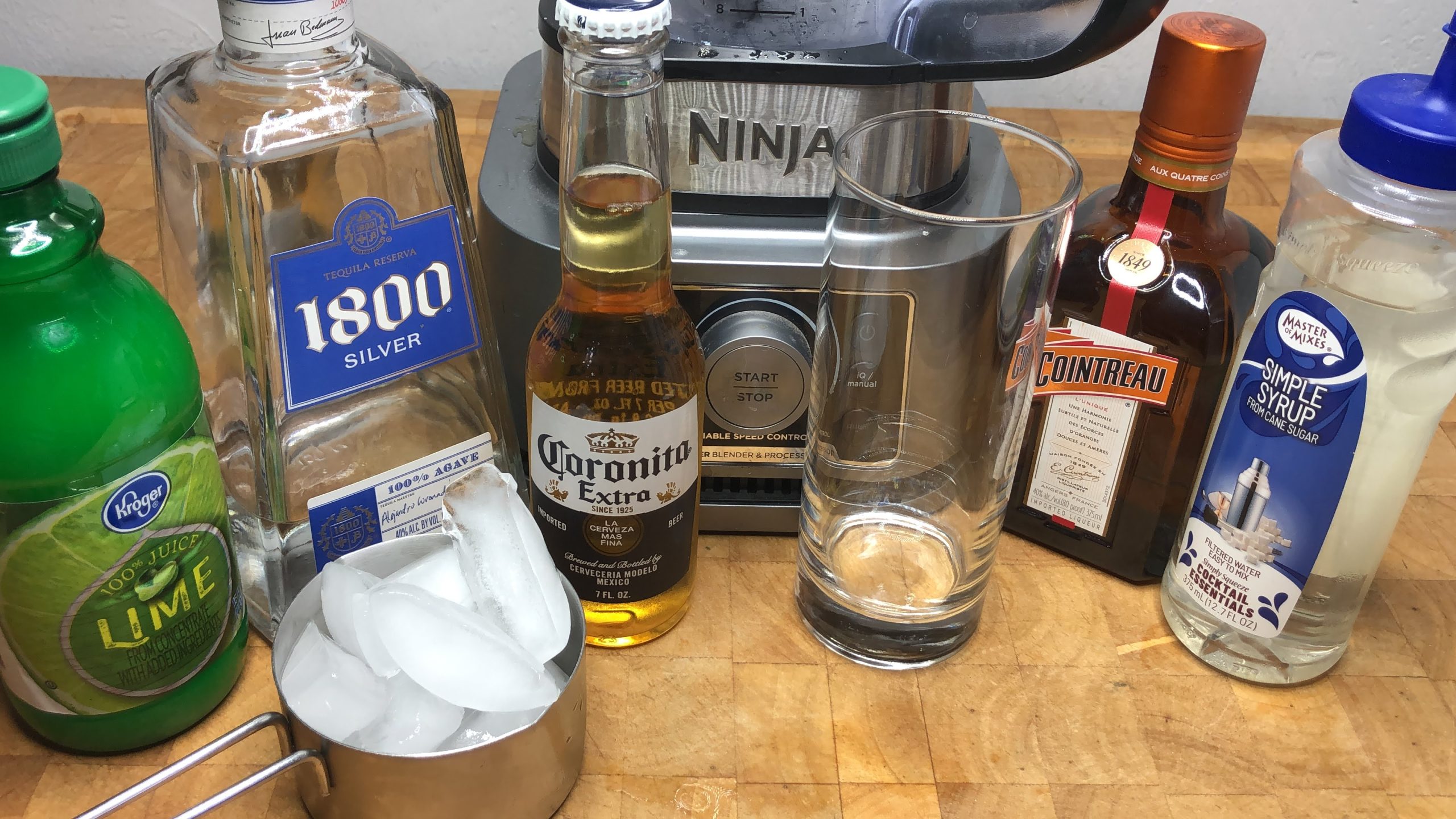 Ingredients for a mexican bulldog drink next to a glass and a blender.