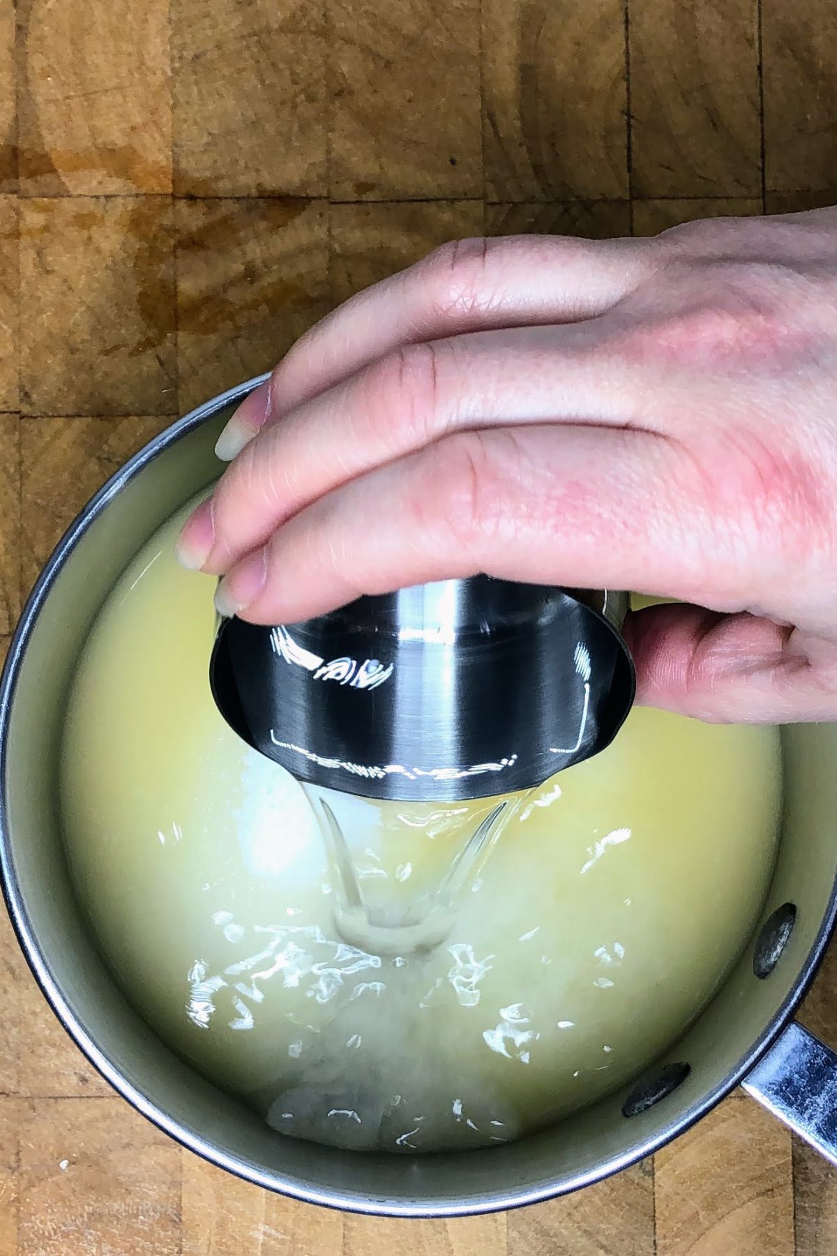 Pouring water into a pot.