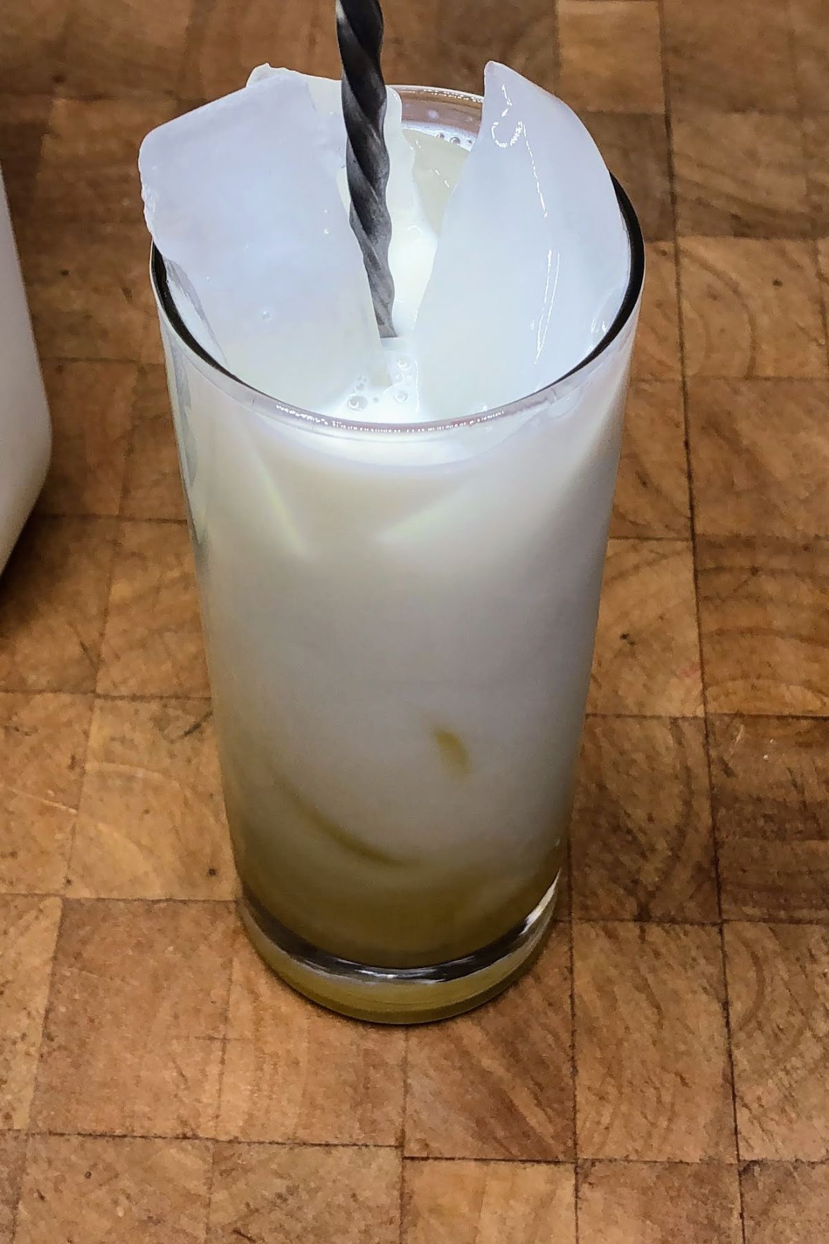 Stirring orange milk with a spoon.