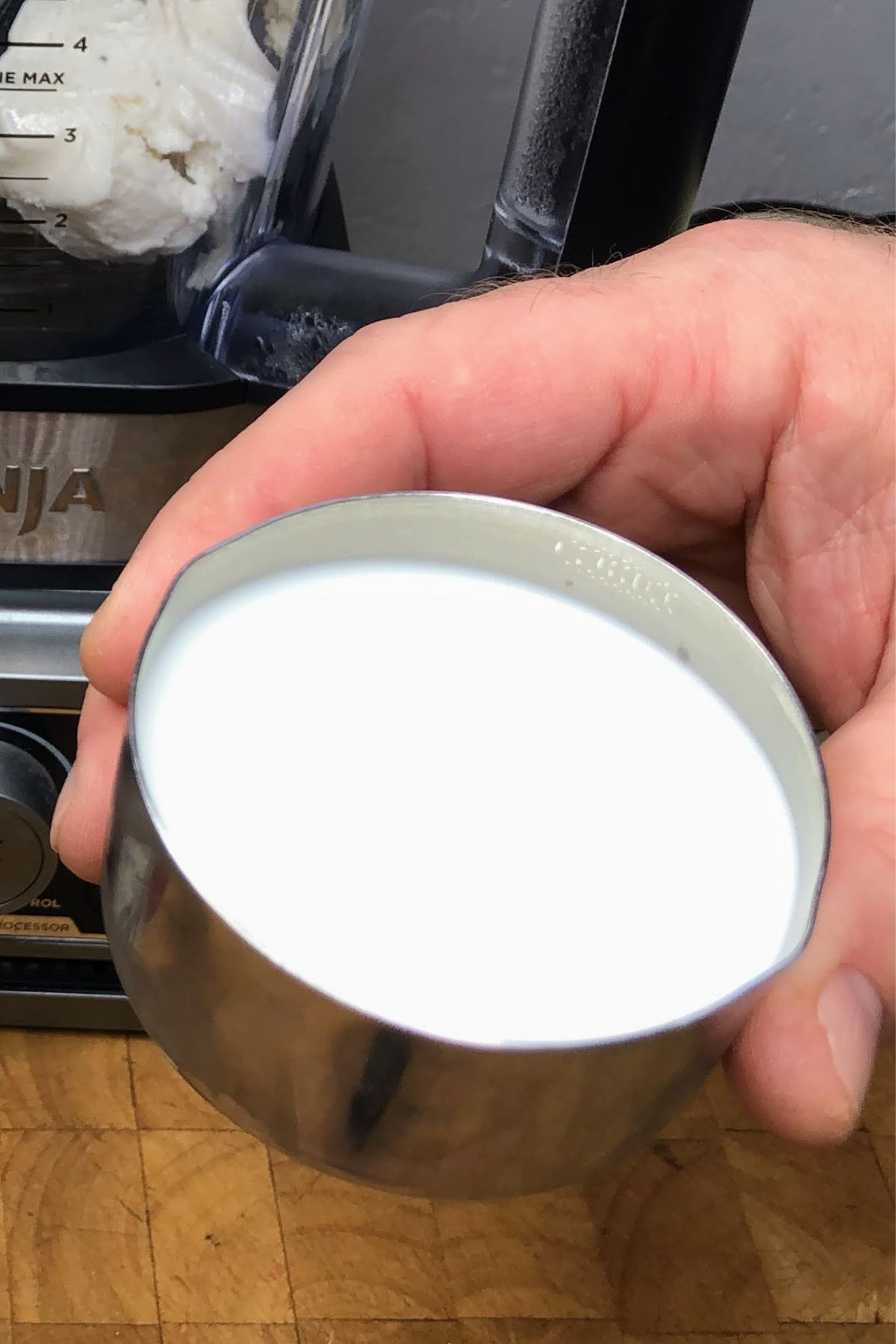 Holding a cup of milk.