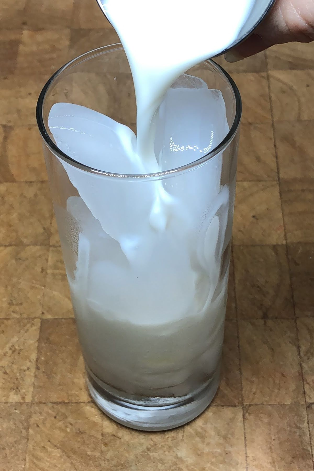Pouring milk into a glass.
