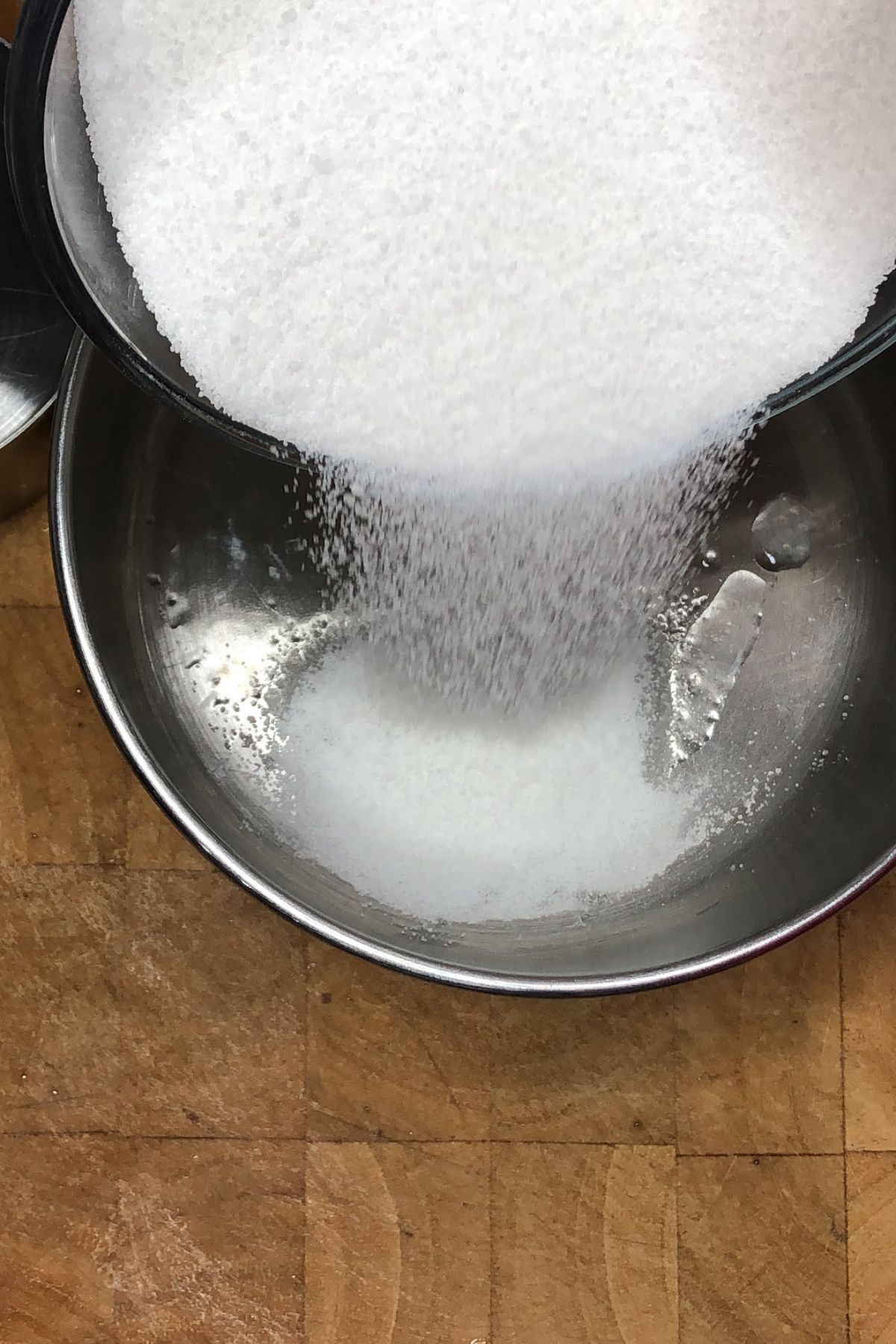 Pouring sugar into a pot.