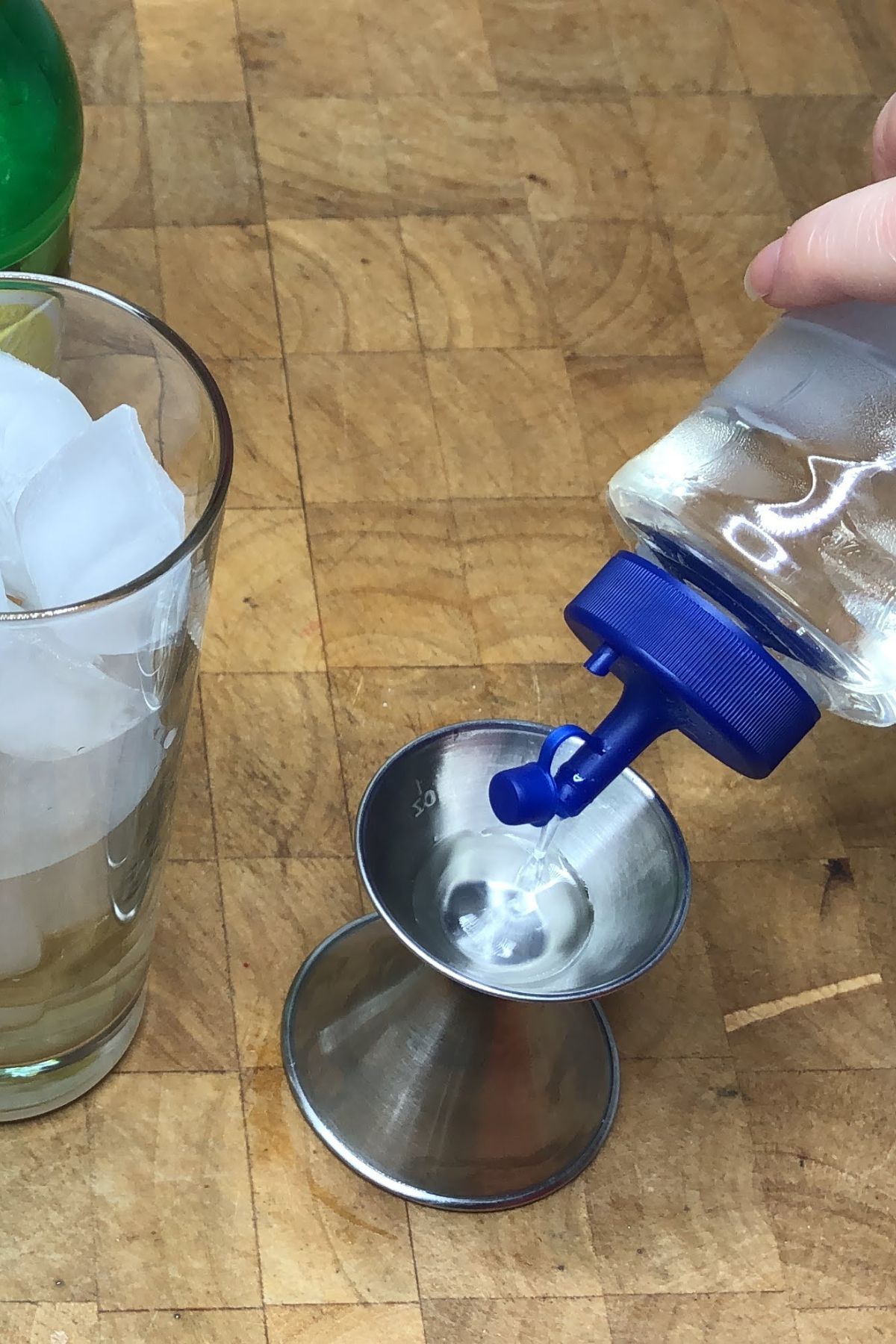 Measuring simple syrup with a jigger.