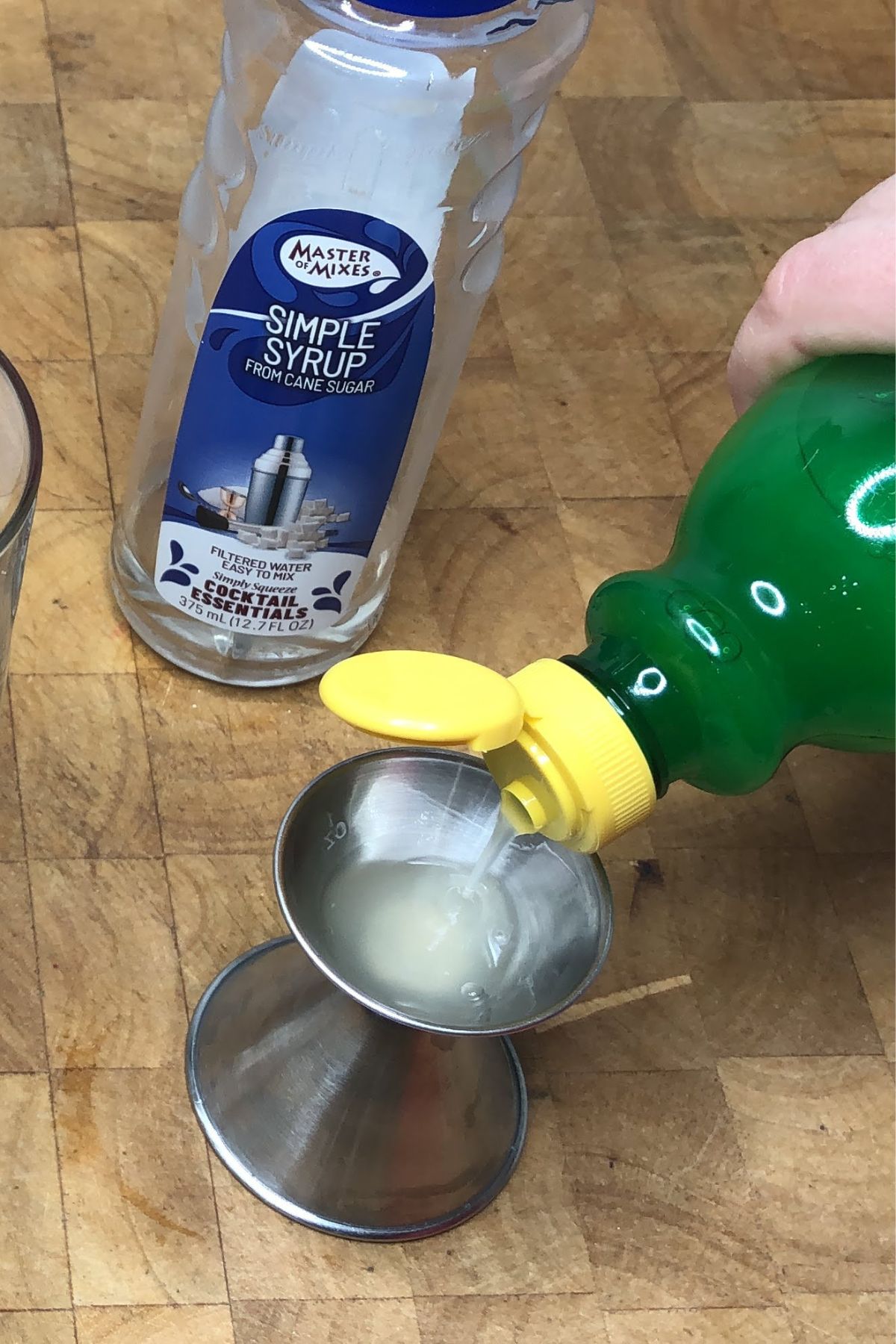 Measuring lemon juice with a jigger.
