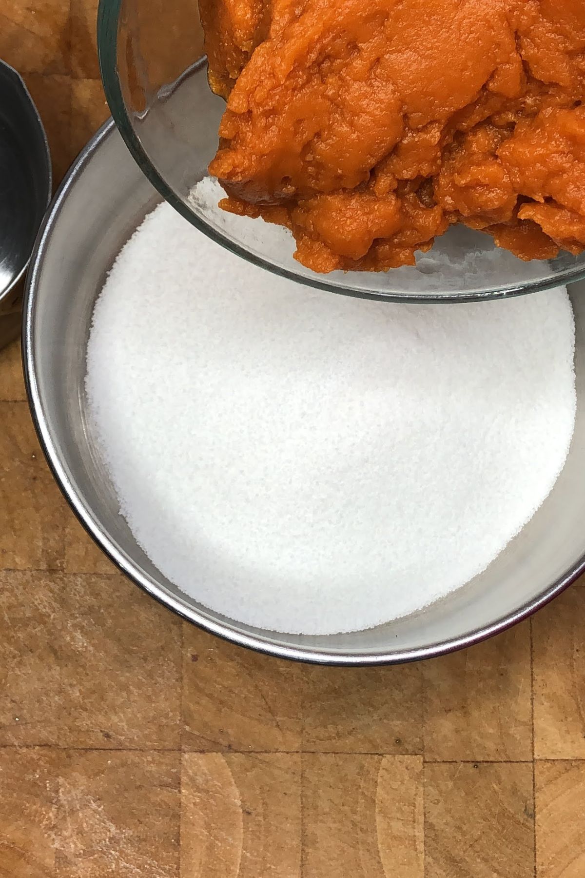 Pouring pumpkin into a saucepan.