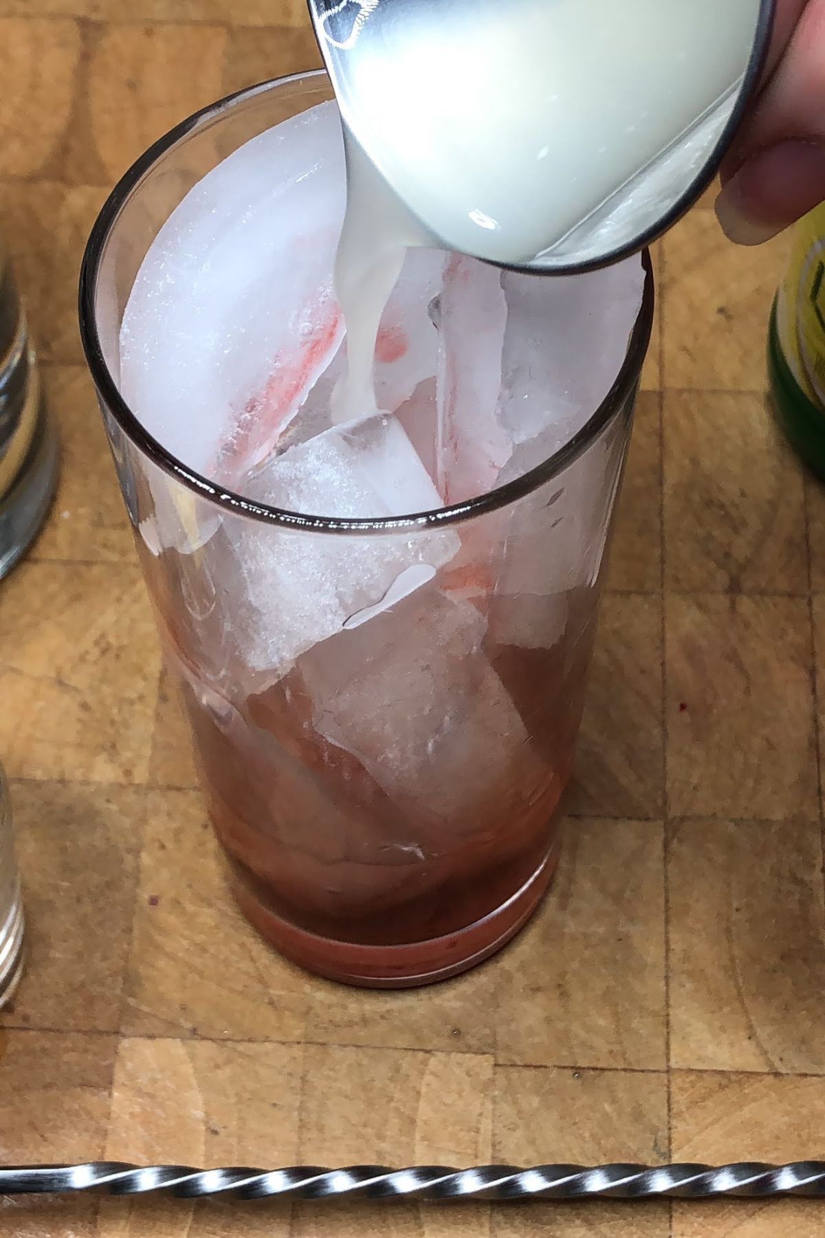 Pouring lemon juice into a glass.