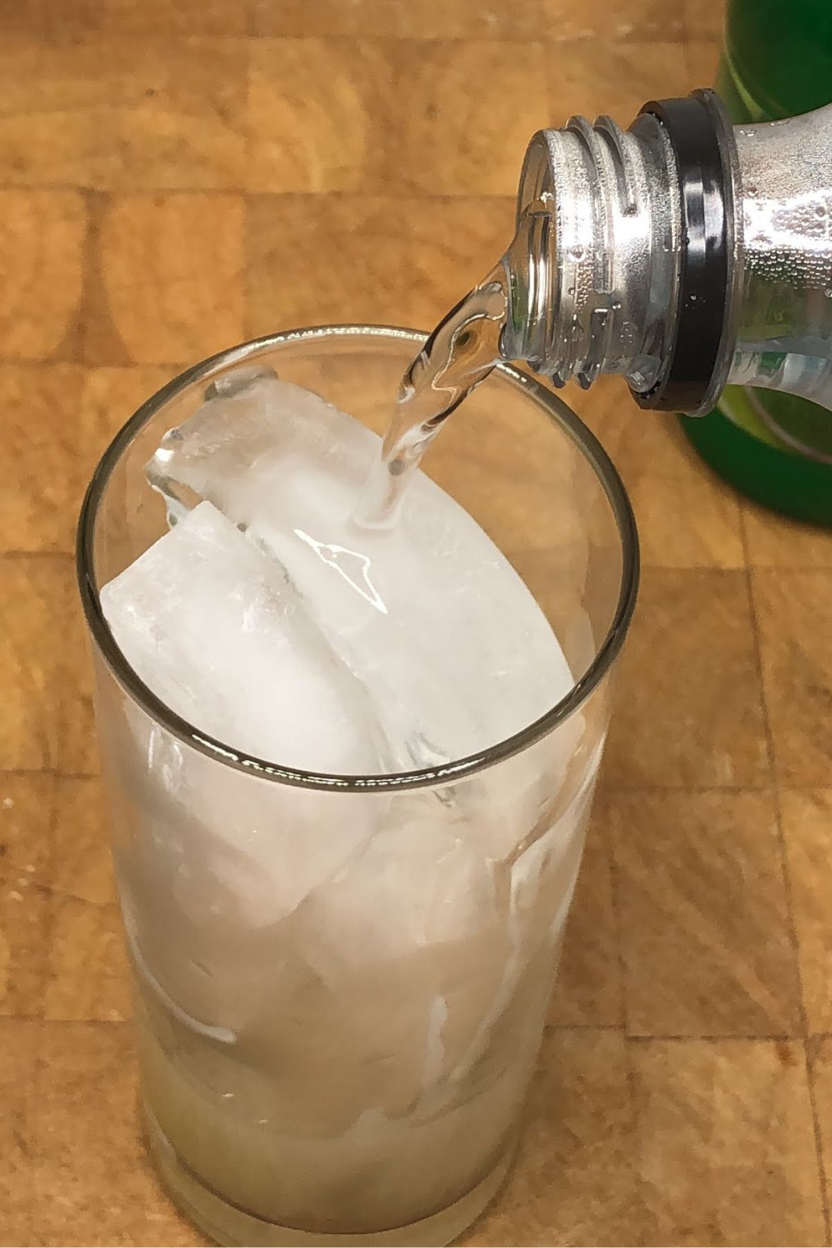 Pouring club soda into a glass.