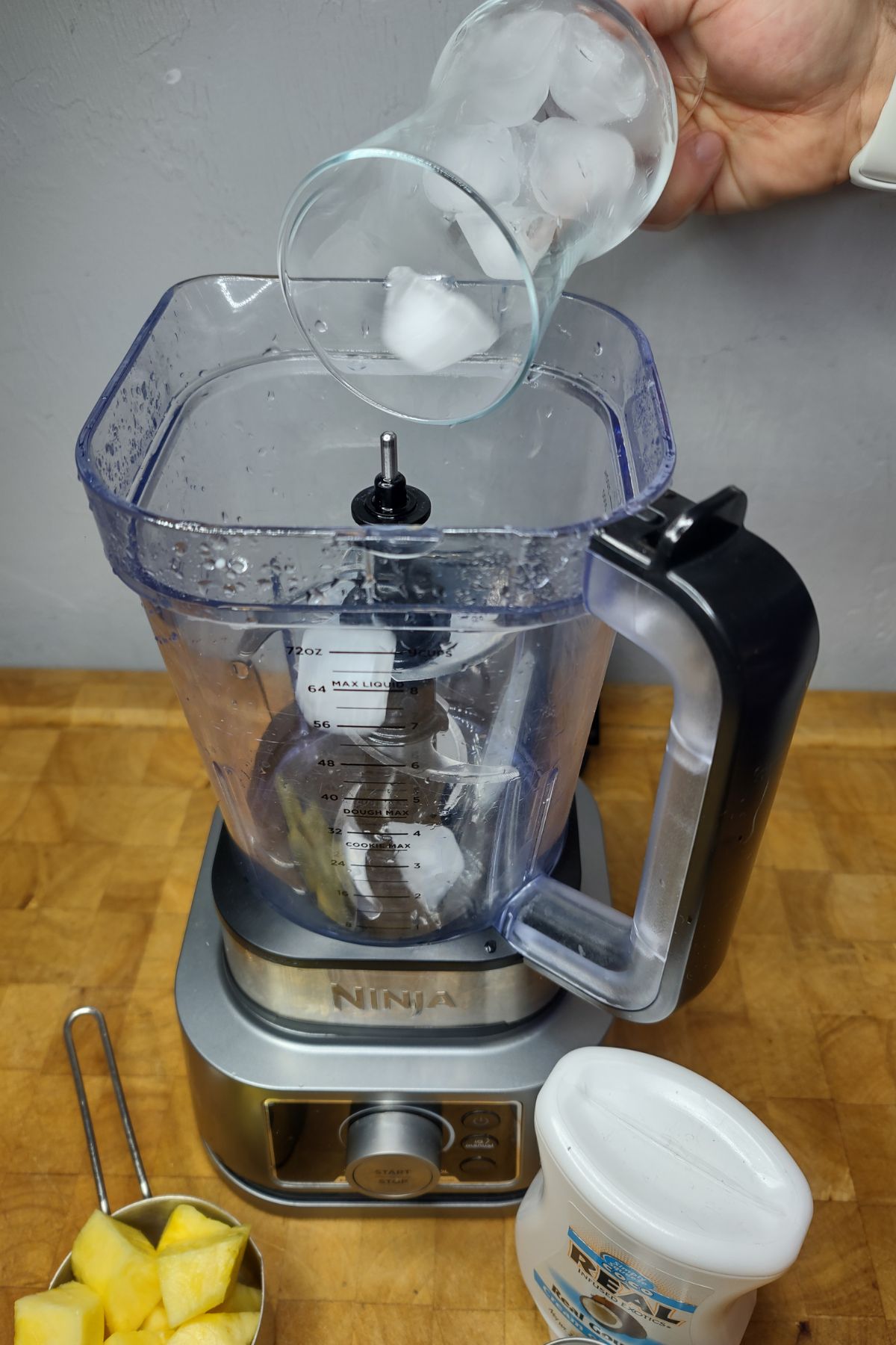 Dumping ice into a blender.