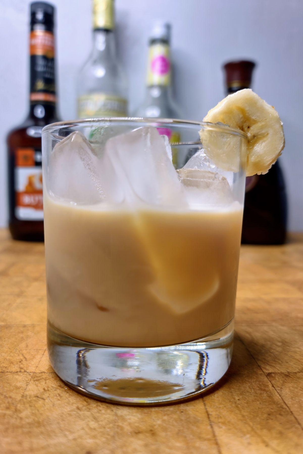 Banana foster drink on a wooden table.