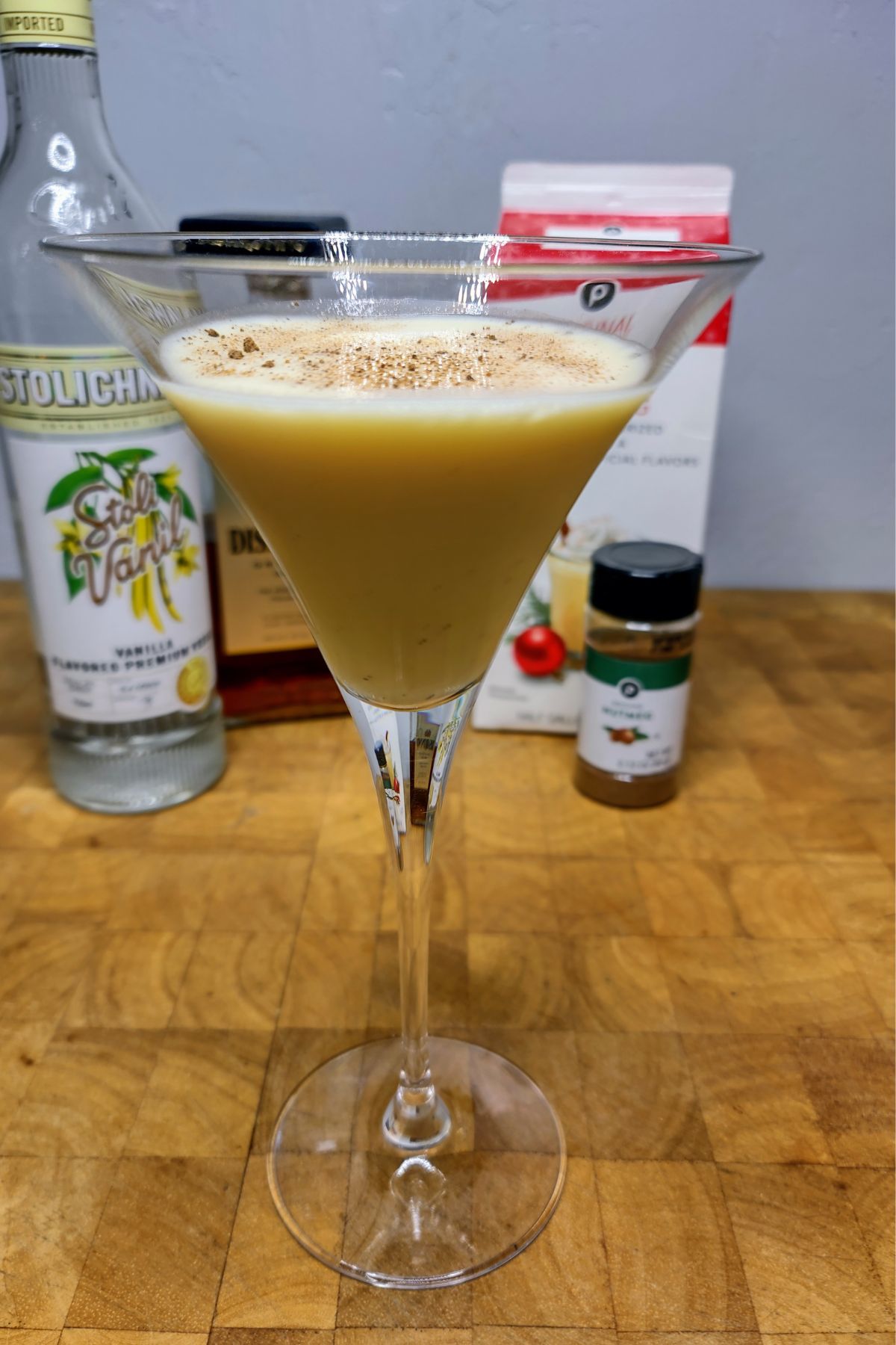 Eggnog martini on a wooden table.