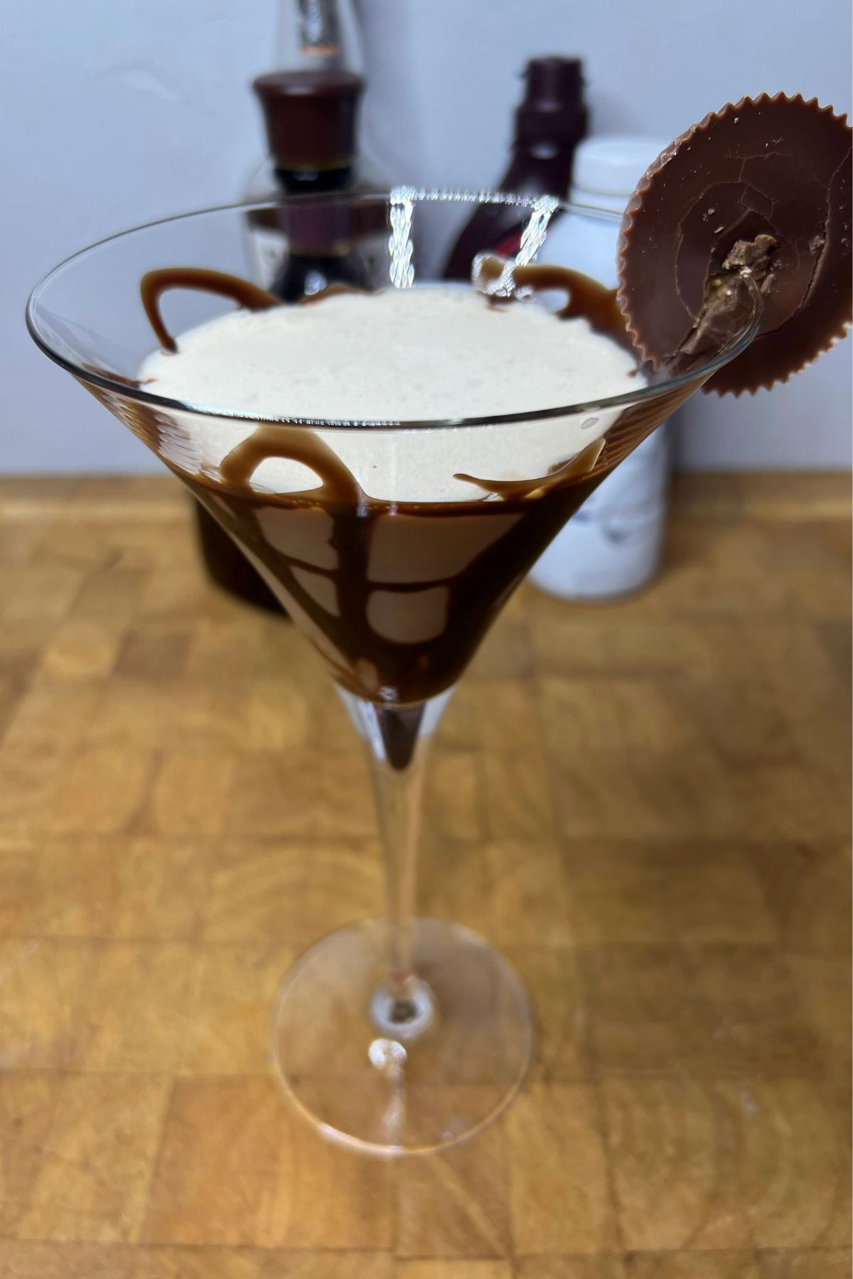 Peanut butter cup martini on a wooden table.